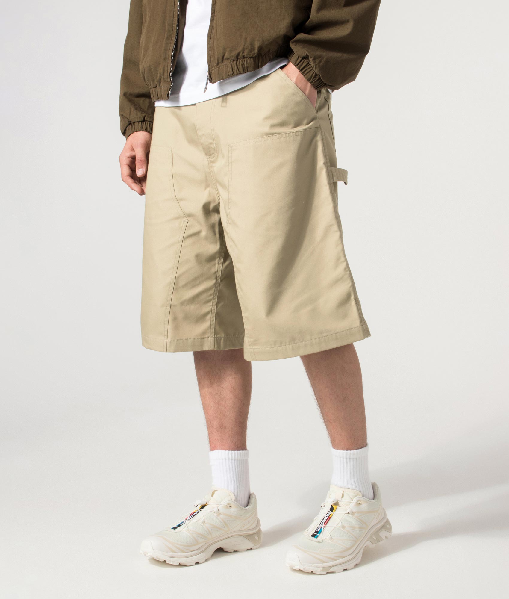 Carhartt WIP release the Postal Double Knee Shorts in Iroko at EQVVS Menswear. Angled model front shot.