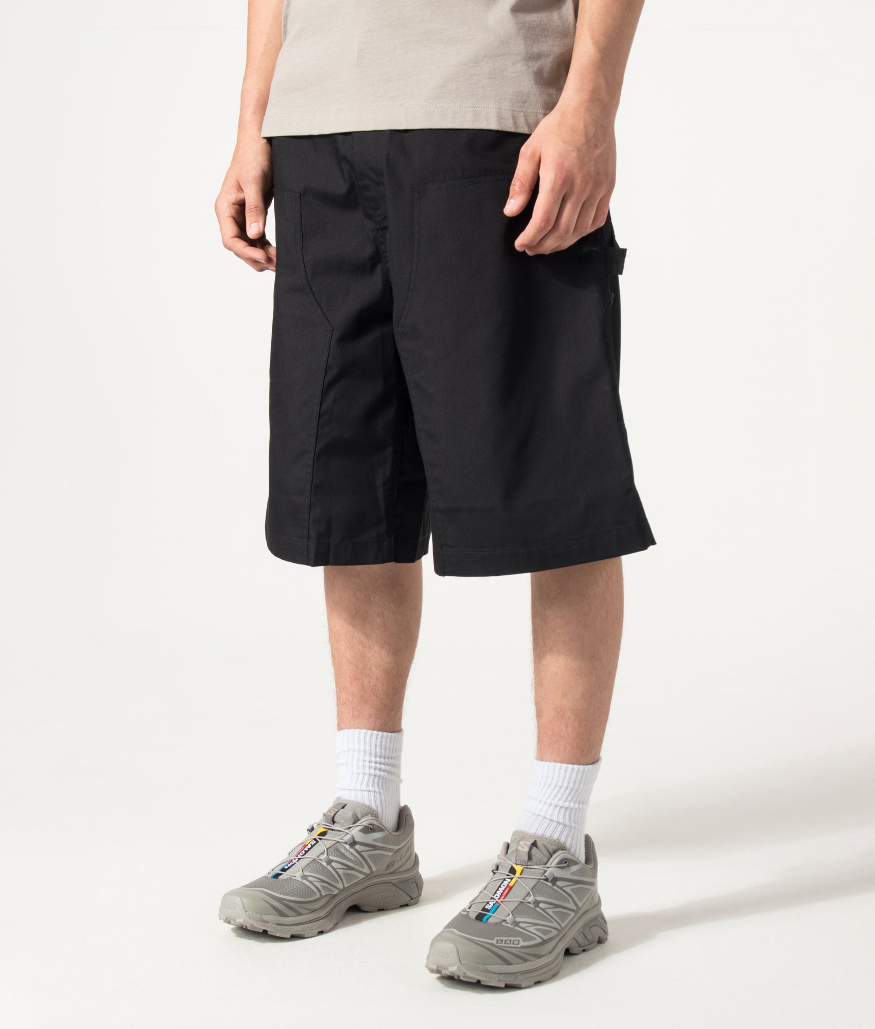 Carhartt WIP Postal Double Knee Shorts in Black at EQVVS Menswear. Angled front shot.