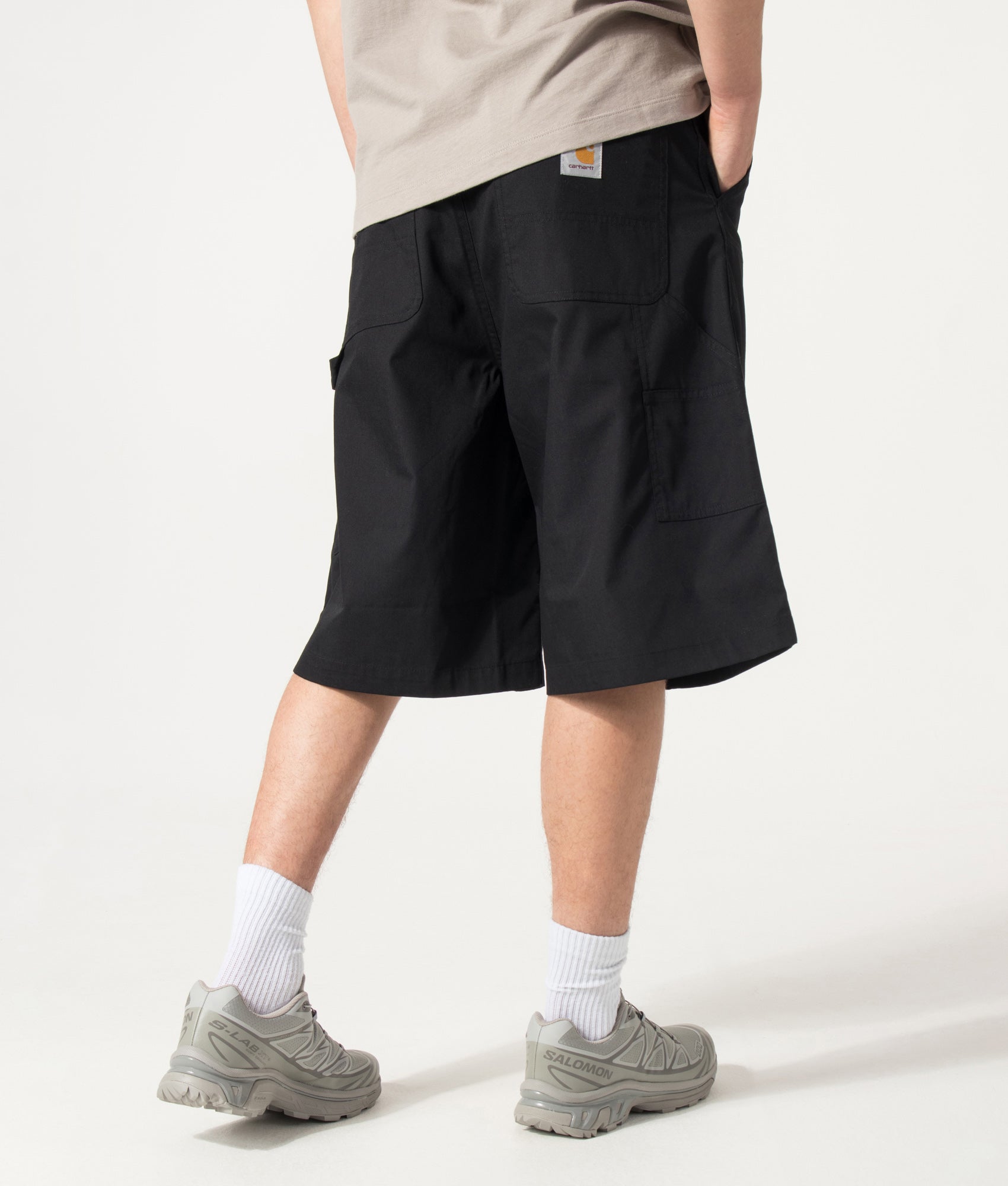 Carhartt WIP Postal Double Knee Shorts in Black at EQVVS Menswear. Angled back shot.