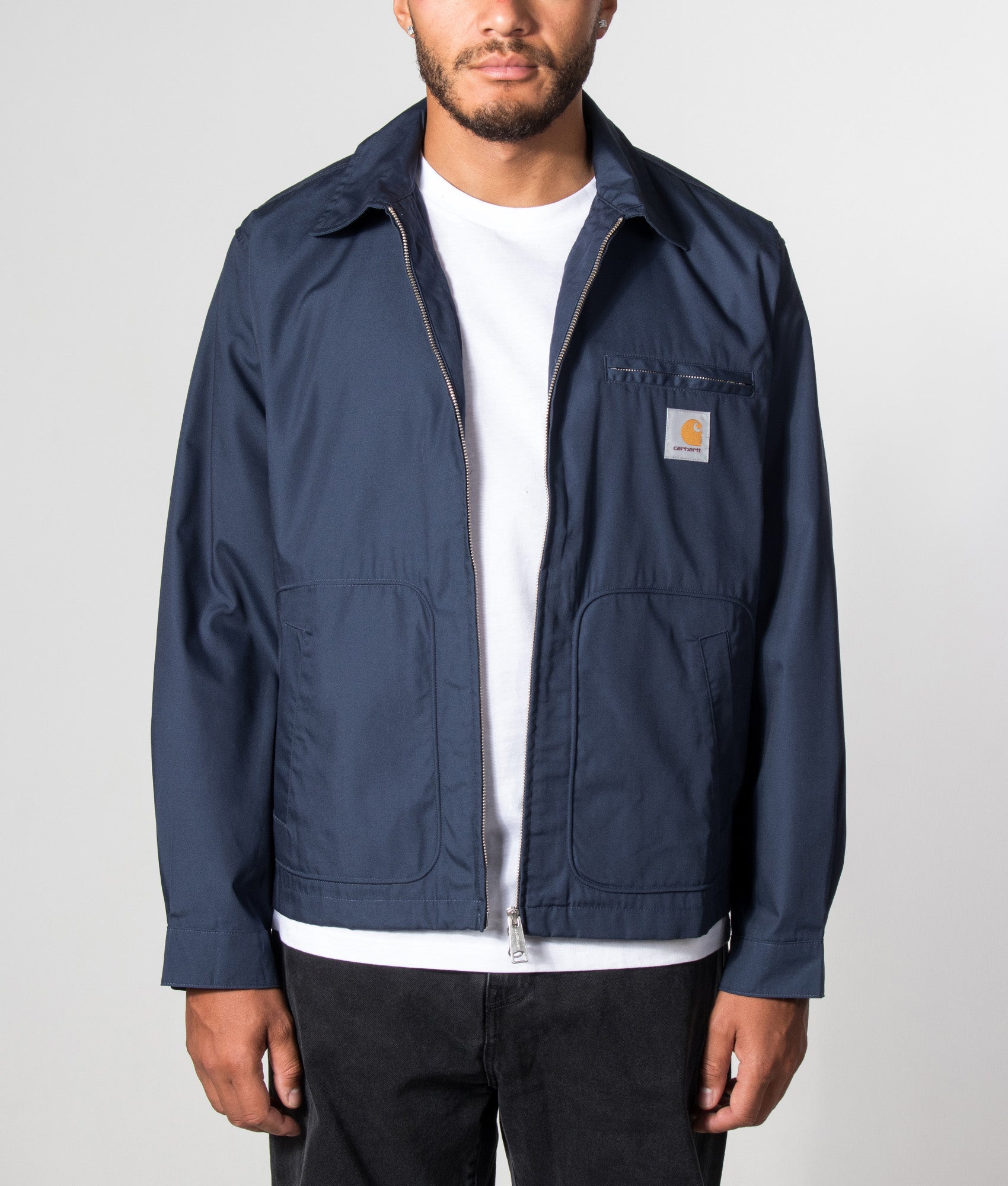 Carhartt WIP Postal Jacket in Blue at EQVVS Menswear.  Model open shot.