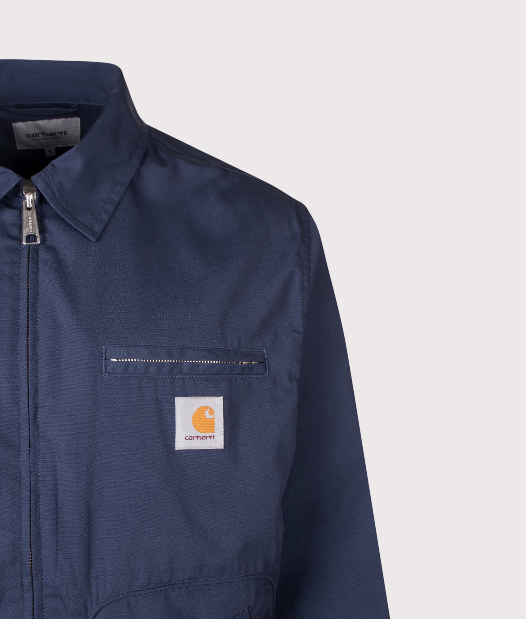 Carhartt WIP Postal Jacket in Blue at EQVVS Menswear. Detail shot.
