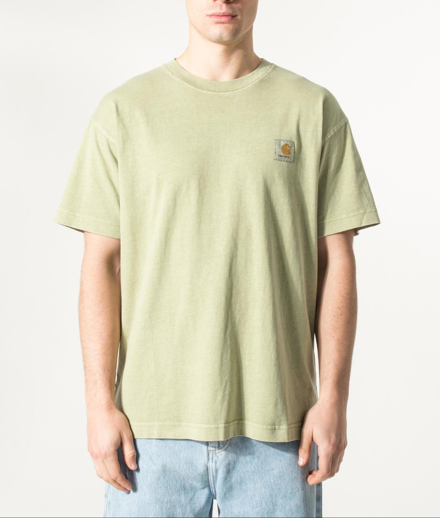 Carhartt WIP Relaxed Fit Nelson T-Shirt in Gentle Green at EQVVS Menswear. Model front shot.