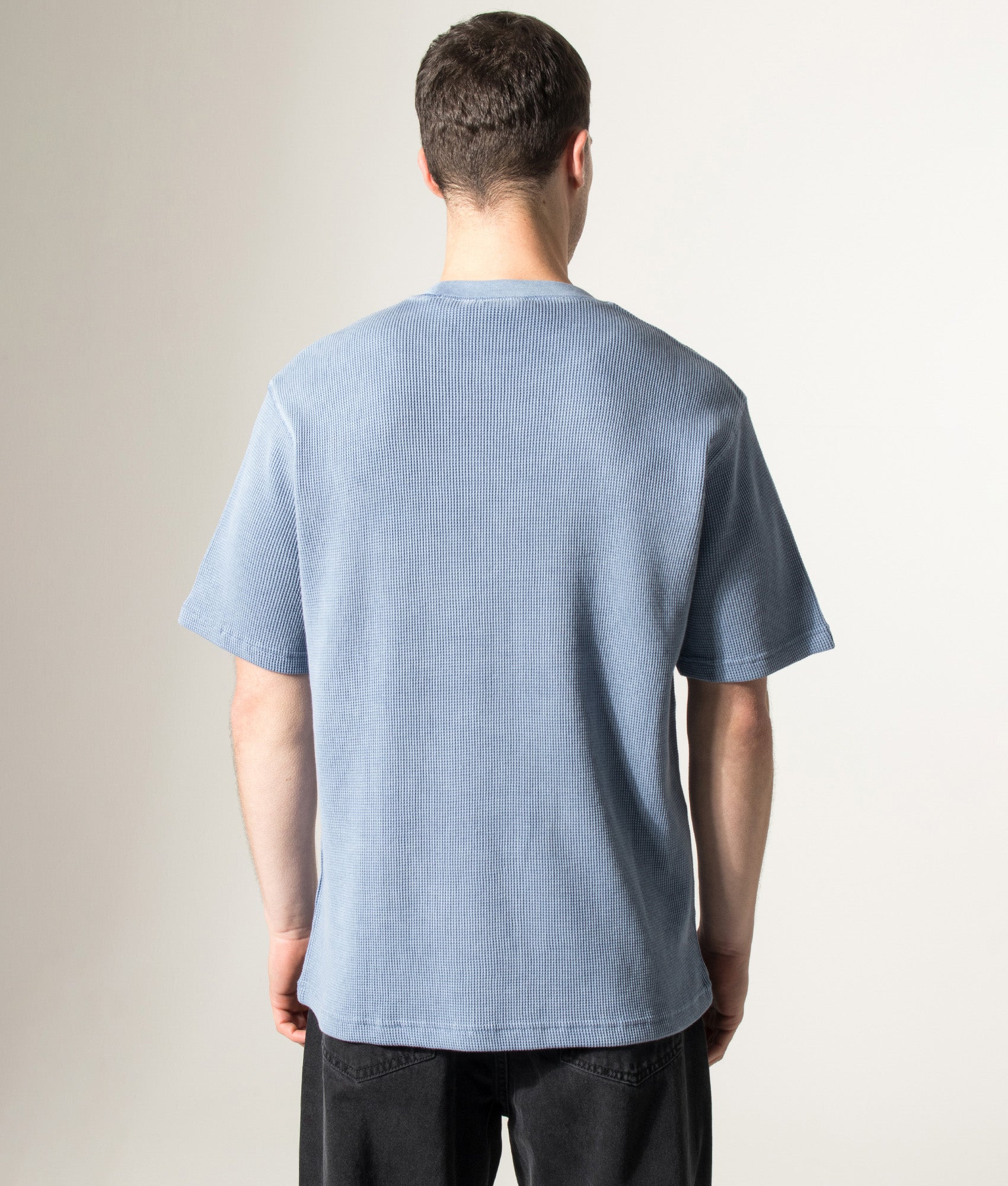 Carhartt WIP Relaxed Fit Nelson Waffle T-Shirt in Gentle Blue at EQVVS Menswear. Model back shot.