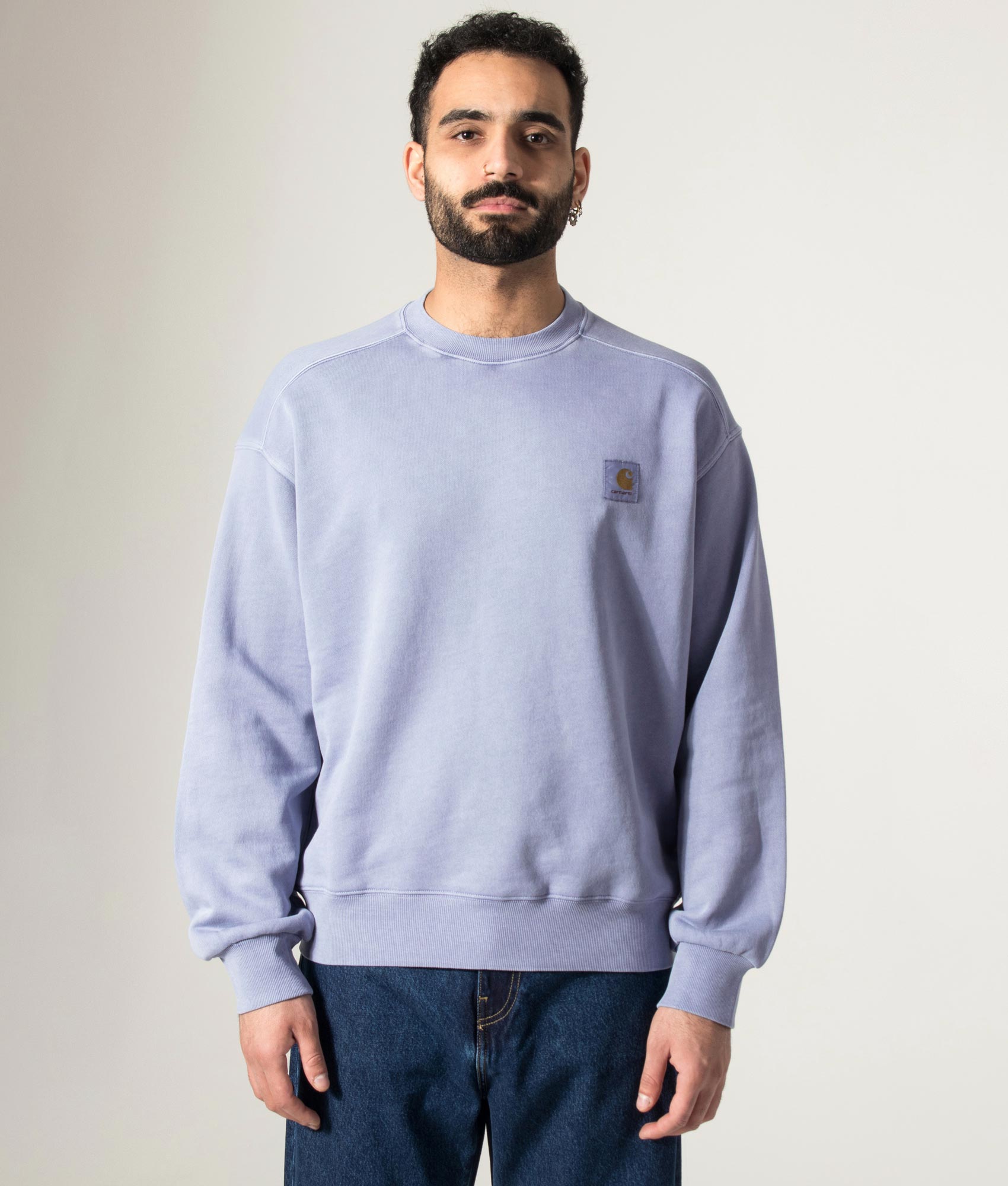 Carhartt WIP Oversized Nelson Sweatshirt in Gentle Blue at EQVVS Menswear. Model front shot.