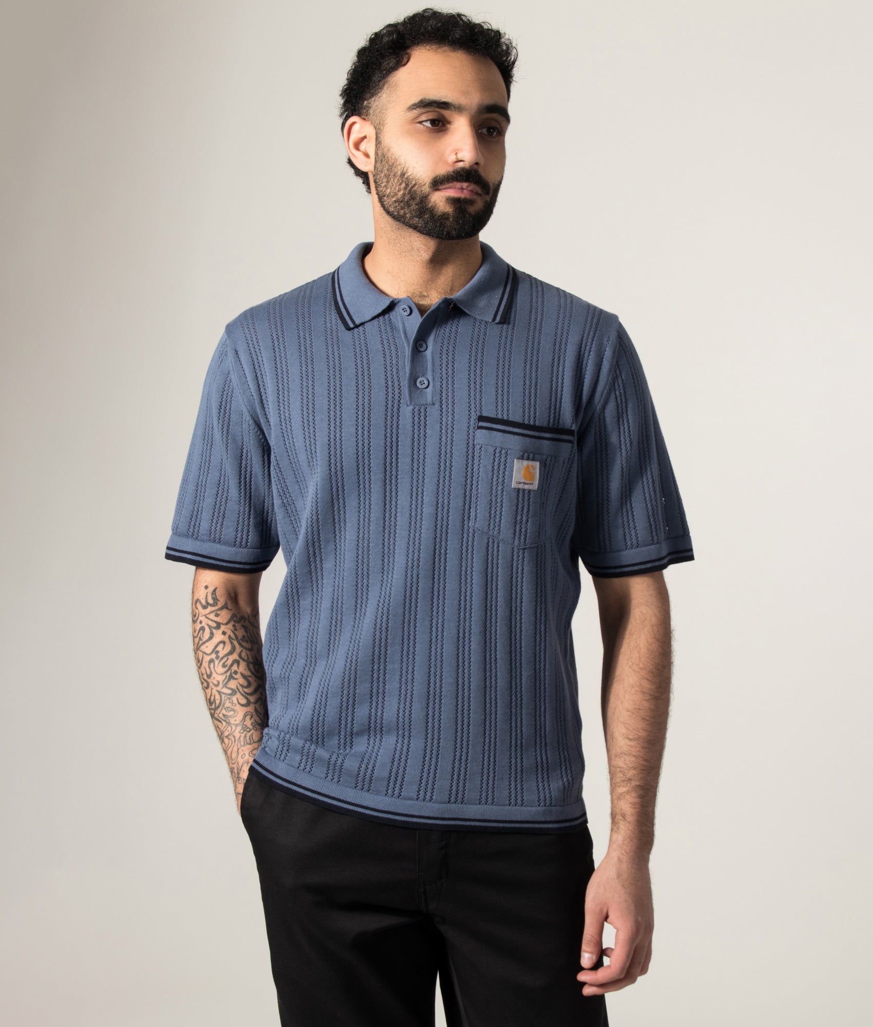 Carhartt WIP Ramsey Polo Shirt in Velvet Blue and Deep Night at EQVVS Menswear. Model front shot.