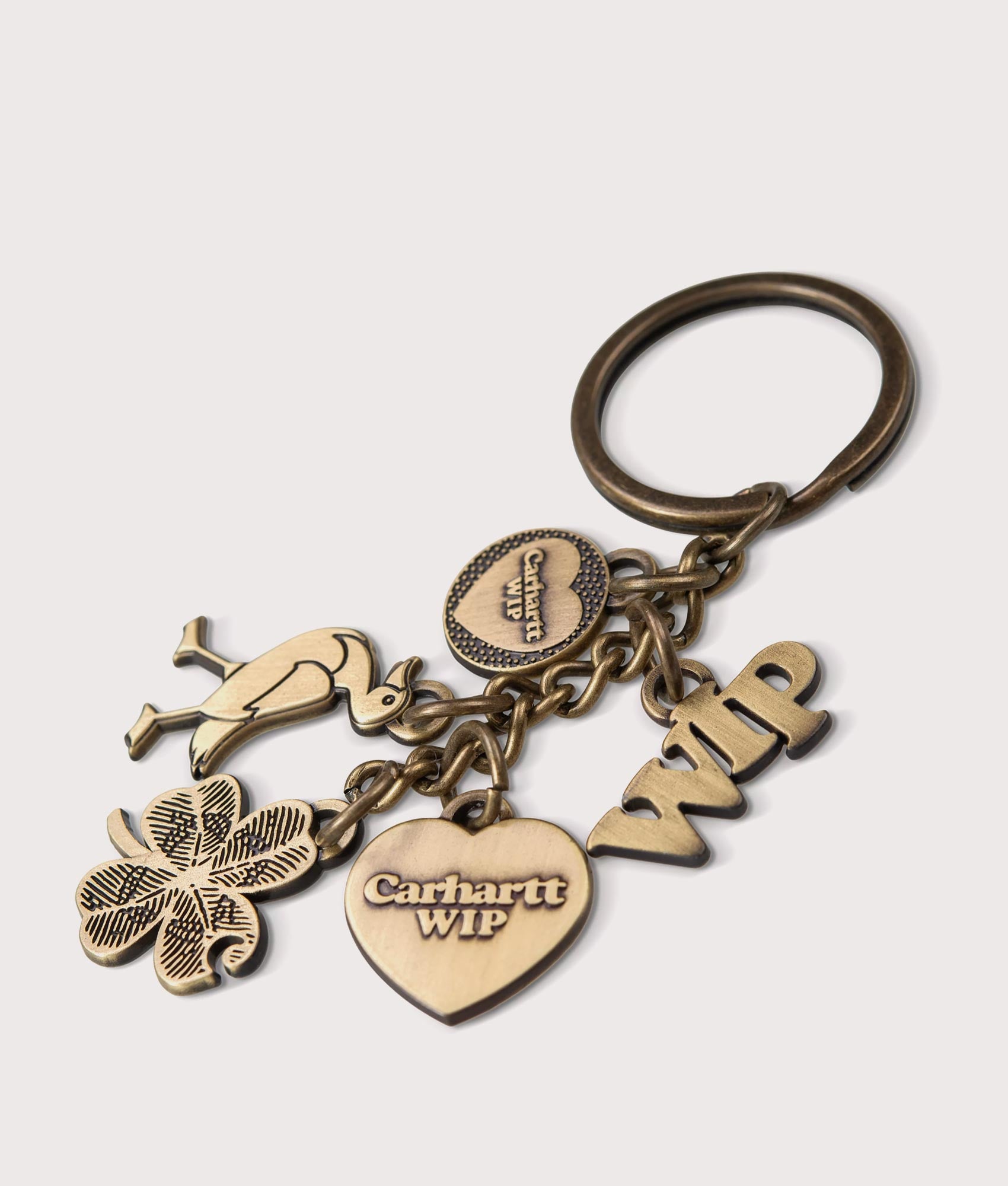  Carhartt WIP Charms Keychain in Gold at EQVVS Menswear. Angle shot.