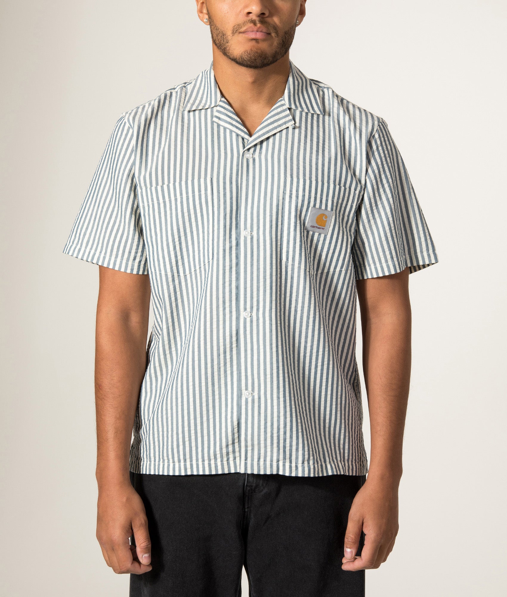 Carhartt WIP Relaxed Fit Short Sleeve Leavel Shirt in Leavel Stripe/Blue River/Wax at EQVVS Menswear. Model front shot.