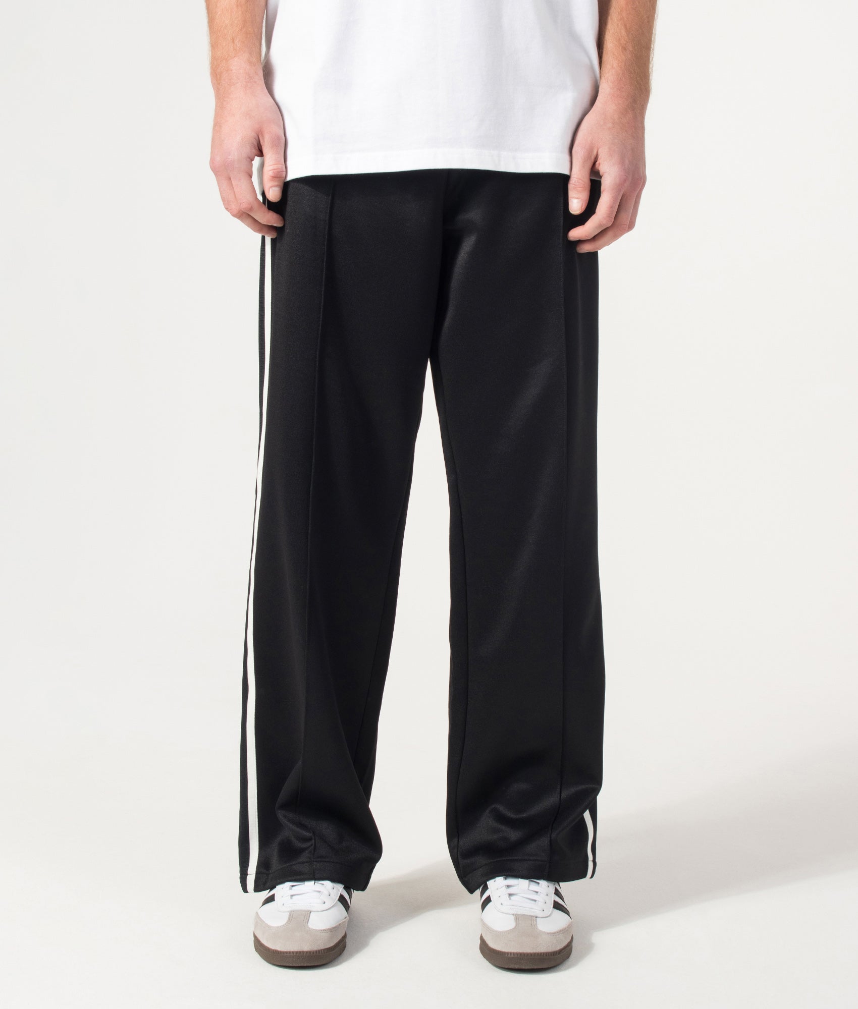 Carhartt WIP Relaxed Fit Bolar Sweat Pants in Black and Wax at EQVVS Menswear. Model front shot.