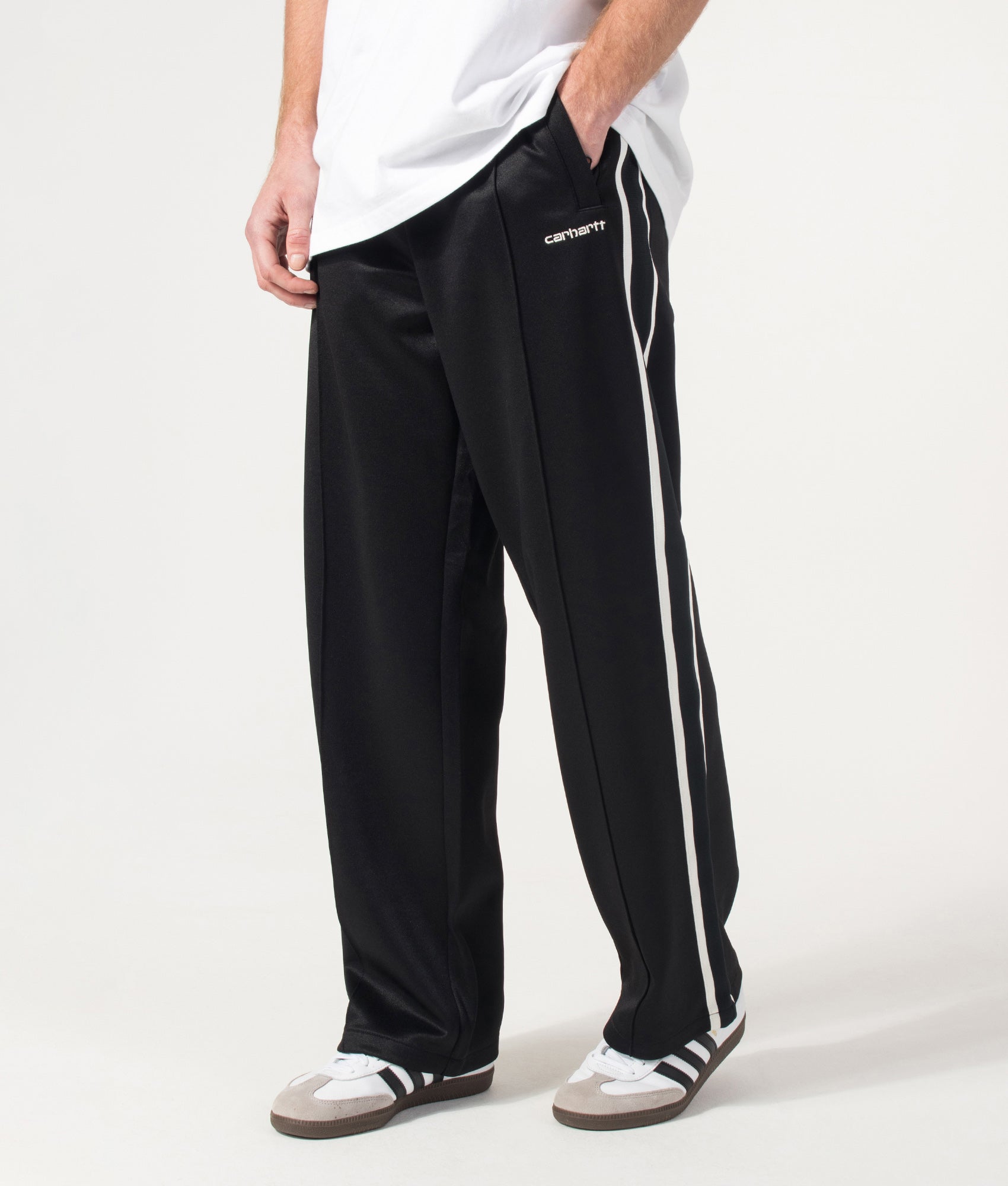 Carhartt WIP Relaxed Fit Bolar Sweat Pants in Black and Wax at EQVVS Menswear. Angled model front shot.