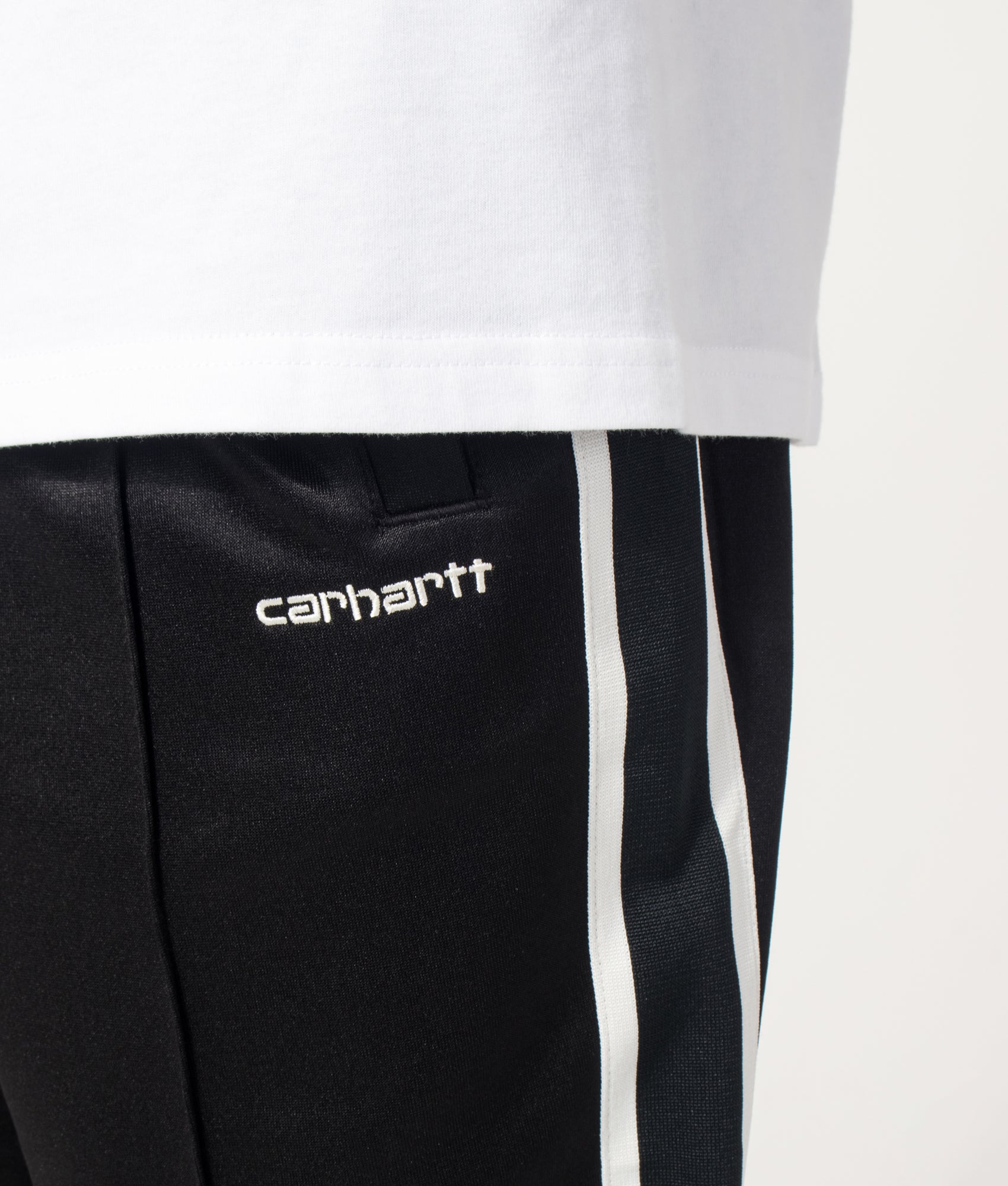 Carhartt WIP Relaxed Fit Bolar Sweat Pants in Black and Wax at EQVVS Menswear. Detail shot.