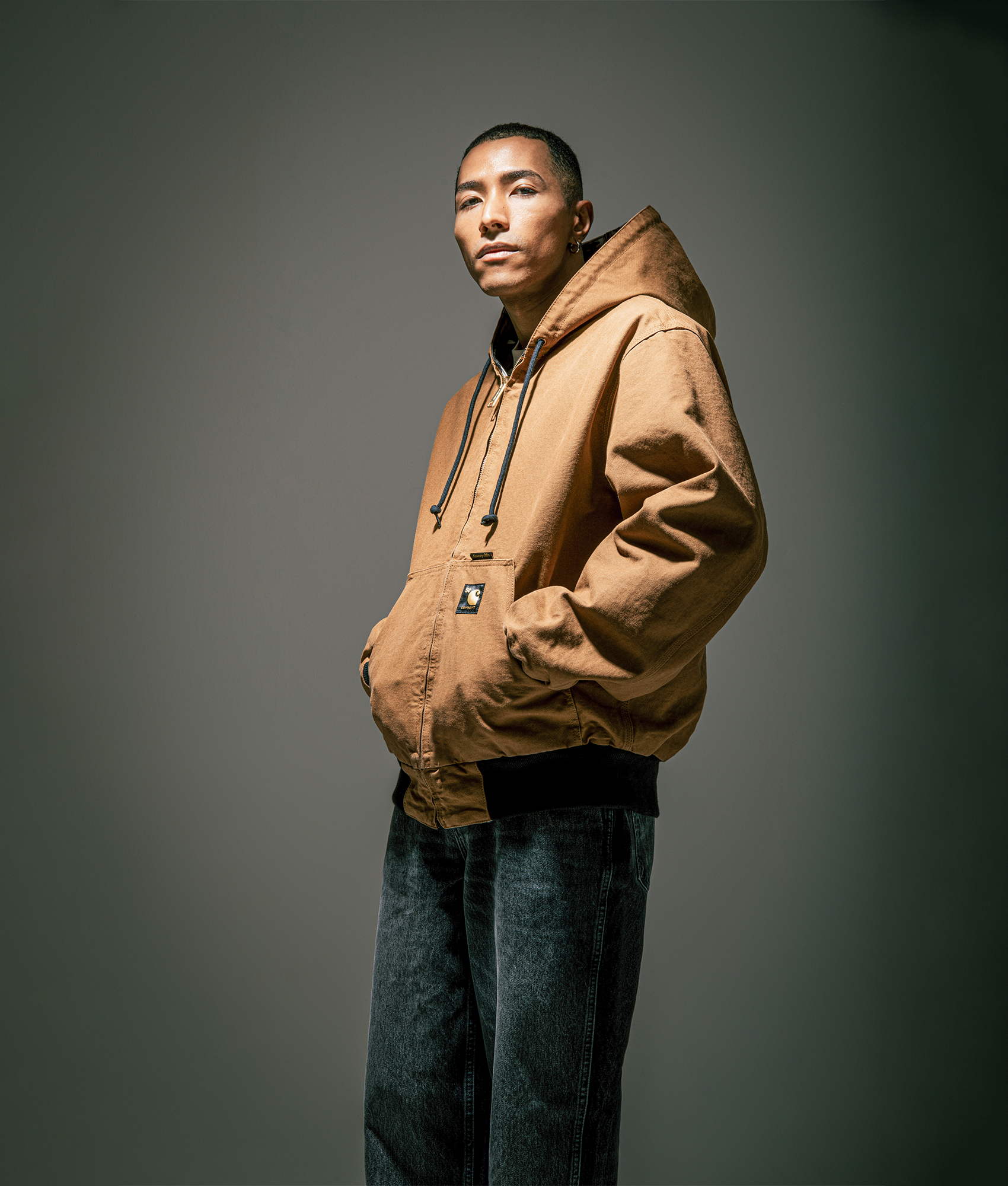Carhartt WIP 50 Years Anniversary OG Active Canvas Jacket in Hamilton Brown/Camo Trebark at EQVVS Menswear. Side A campaign shot.