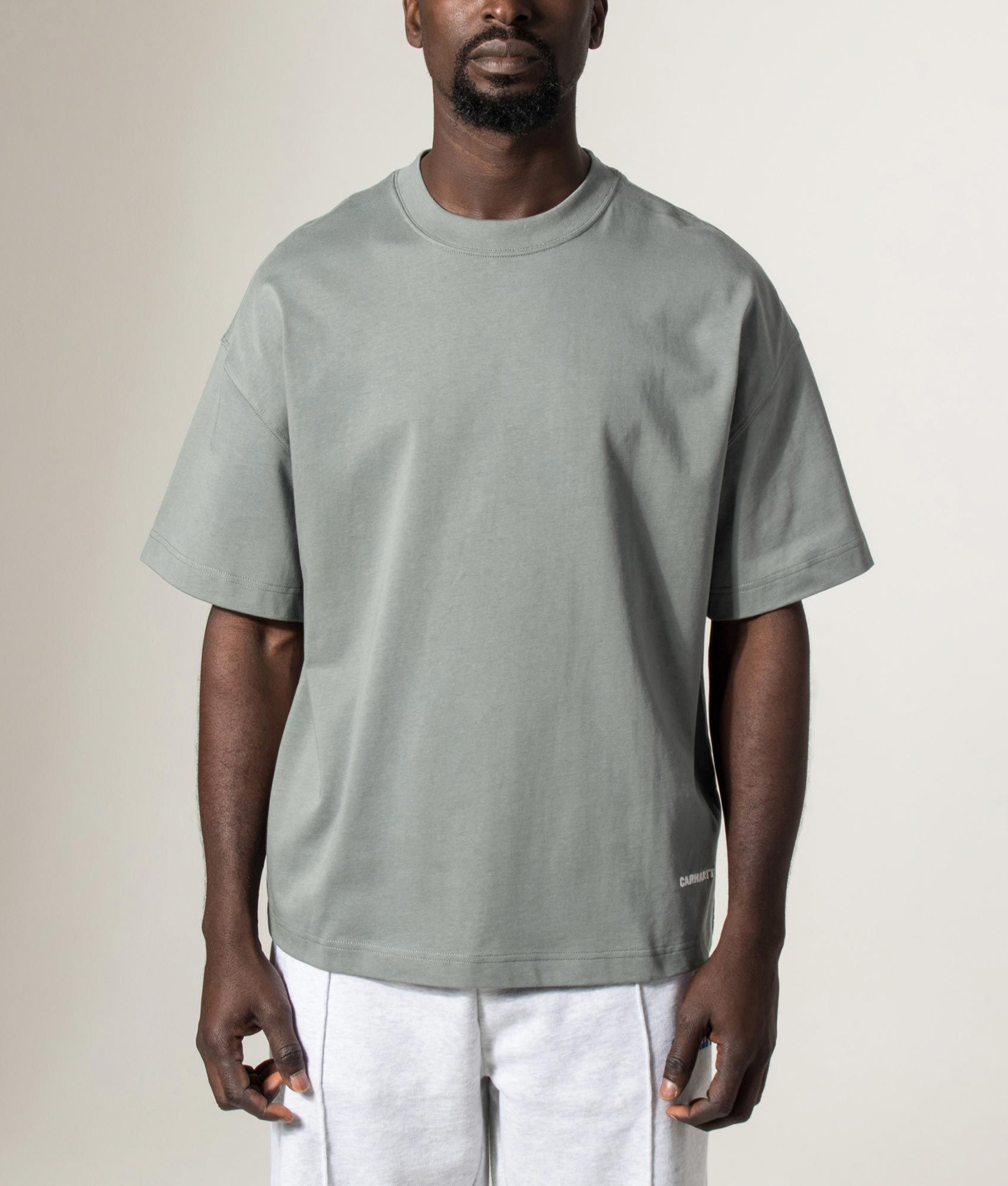 Carhartt WIP Boxy Loose Fit Link Script T-Shirt in Velvet Green and White at EQVVS Menswear. Model front shot.