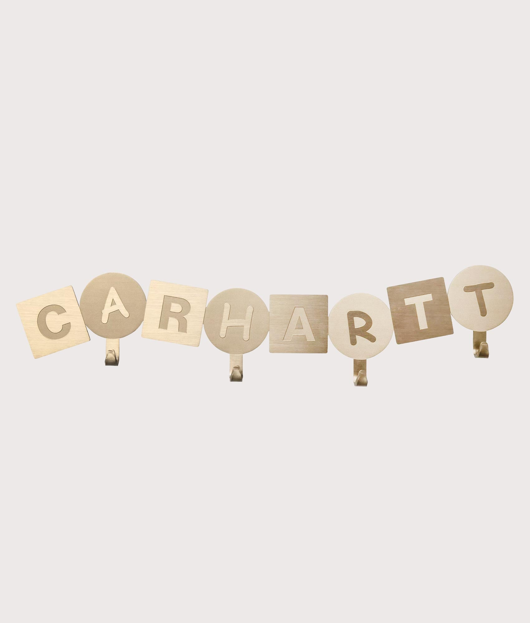 Carhartt WIP ABC Wall Coat Hanger in Gold at EQVVS Menswear. Front shot. 