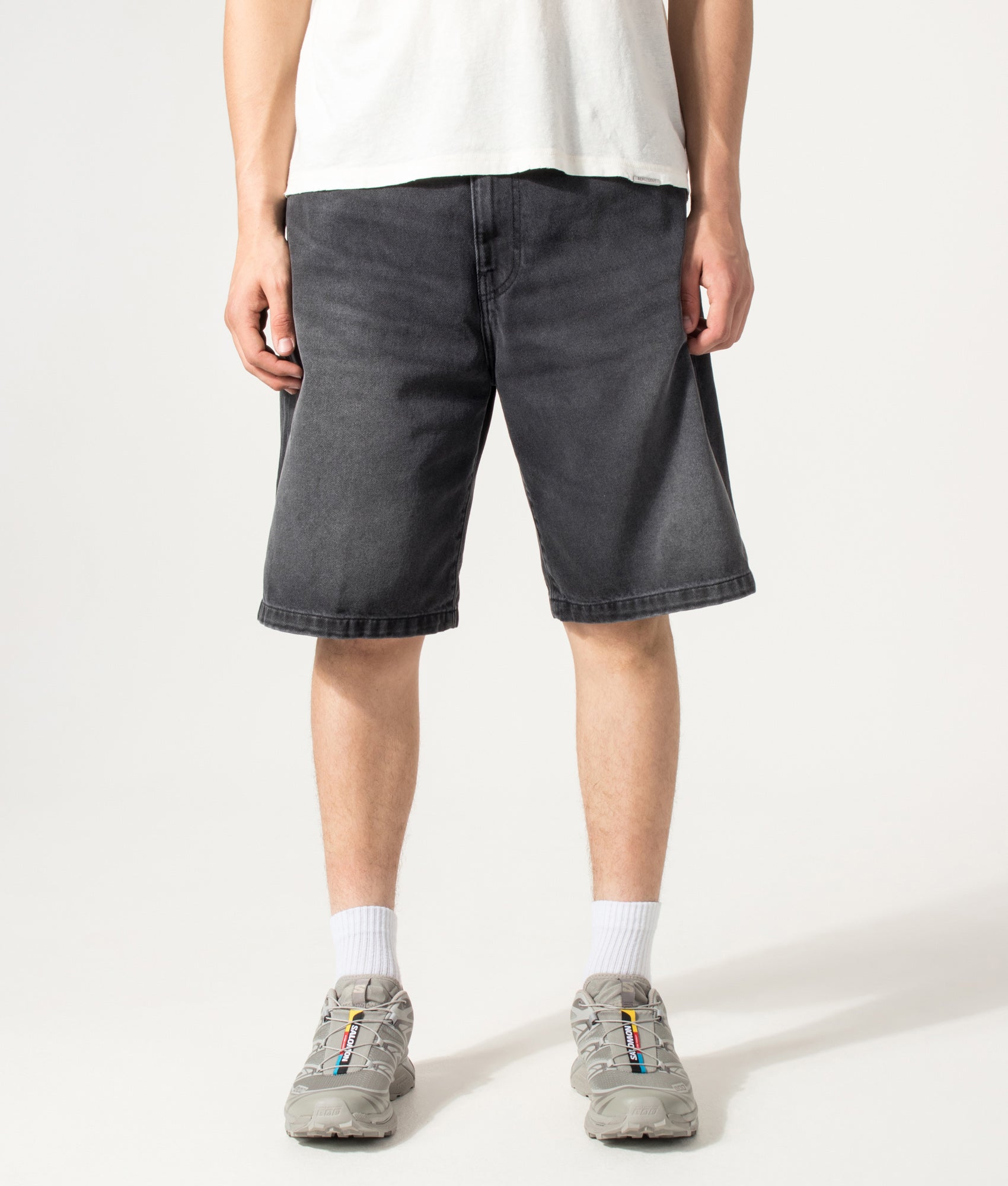 Carhartt WIP Loose Fit Landon Denim Shorts in Worn Bleached Black at EQVVS Menswear. Model front shot.