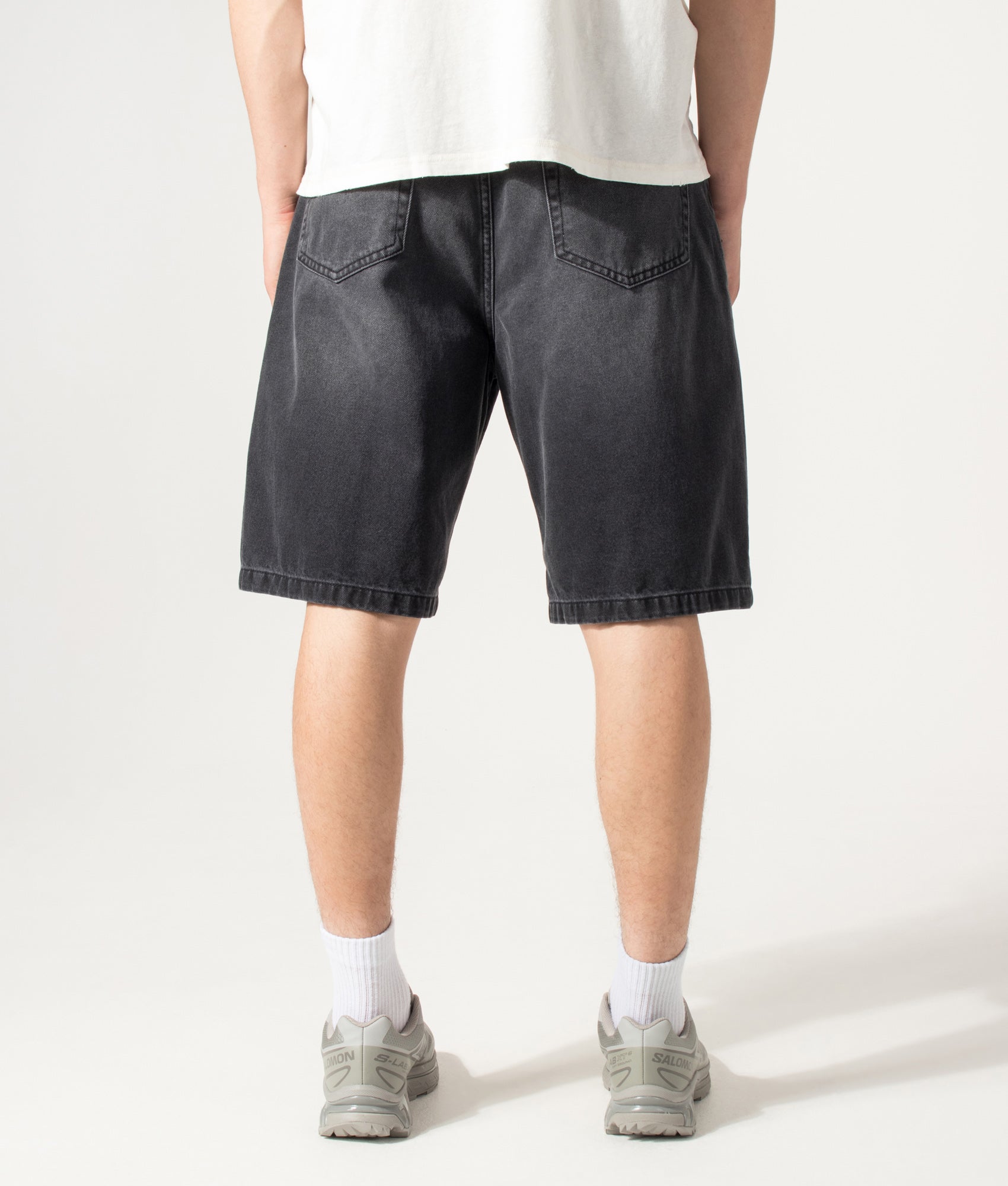 Carhartt WIP Loose Fit Landon Denim Shorts in Worn Bleached Black at EQVVS Menswear. Model back shot.