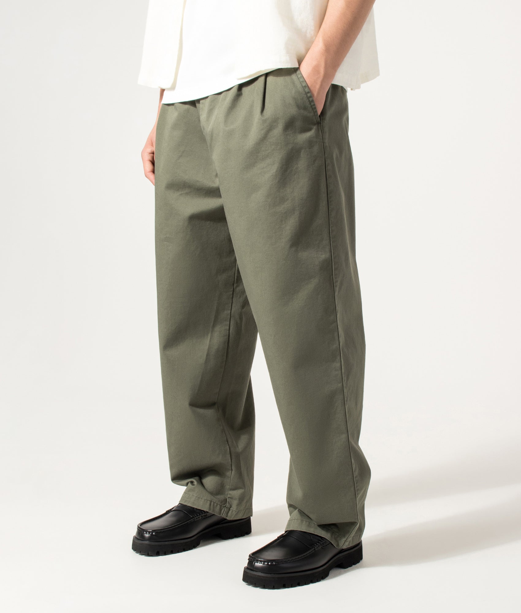 Carhartt WIP Marv Pants in Leaf at EQVVS Menswear. Angled model front shot.