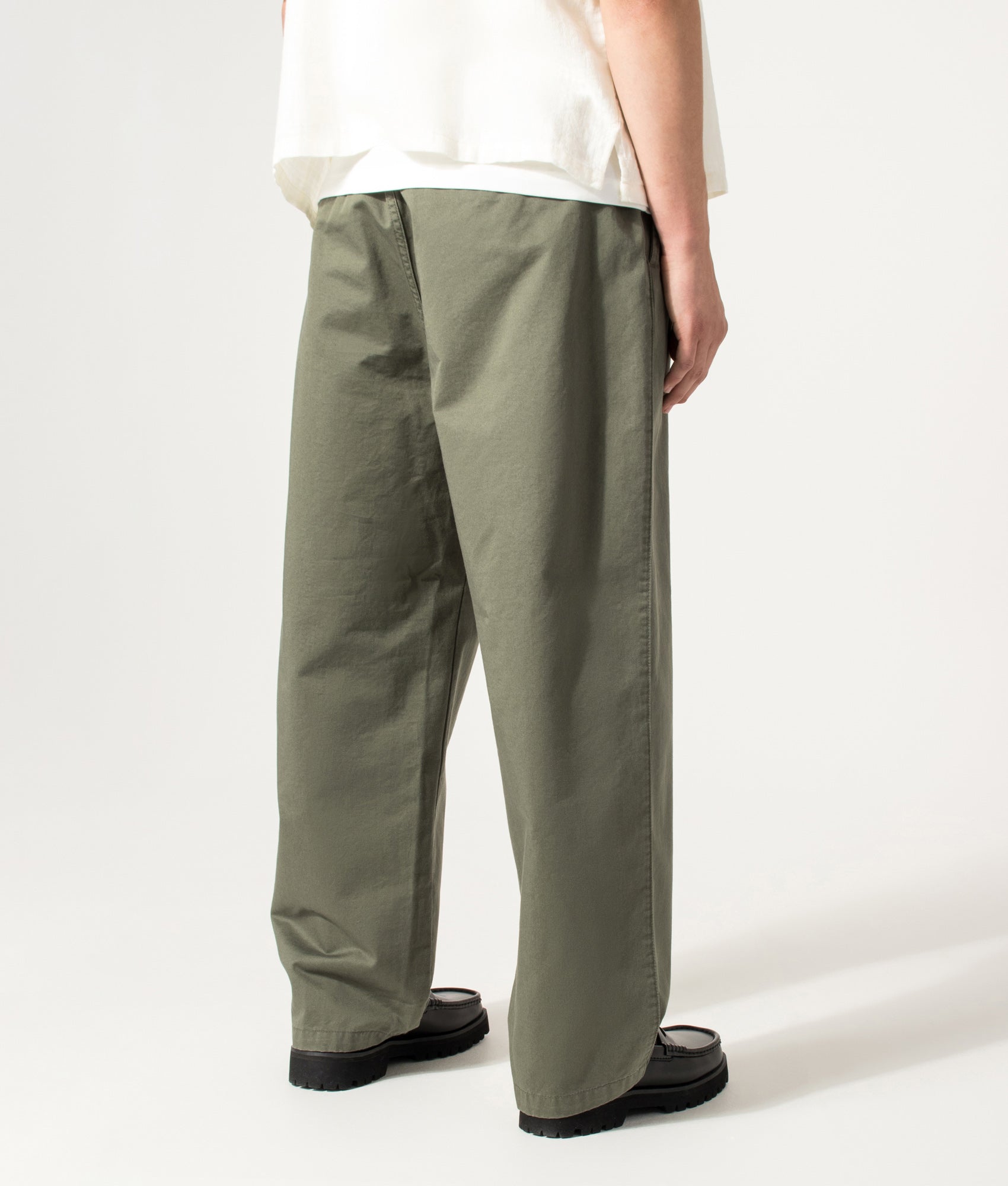 Carhartt WIP Marv Pants in Leaf at EQVVS Menswear. Angled model back shot.