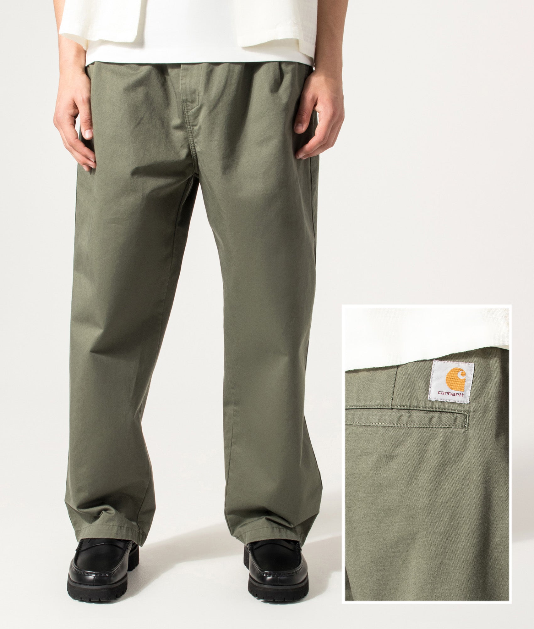 Carhartt WIP Marv Pants in Leaf at EQVVS Menswear. Model front shot and back detail shot.