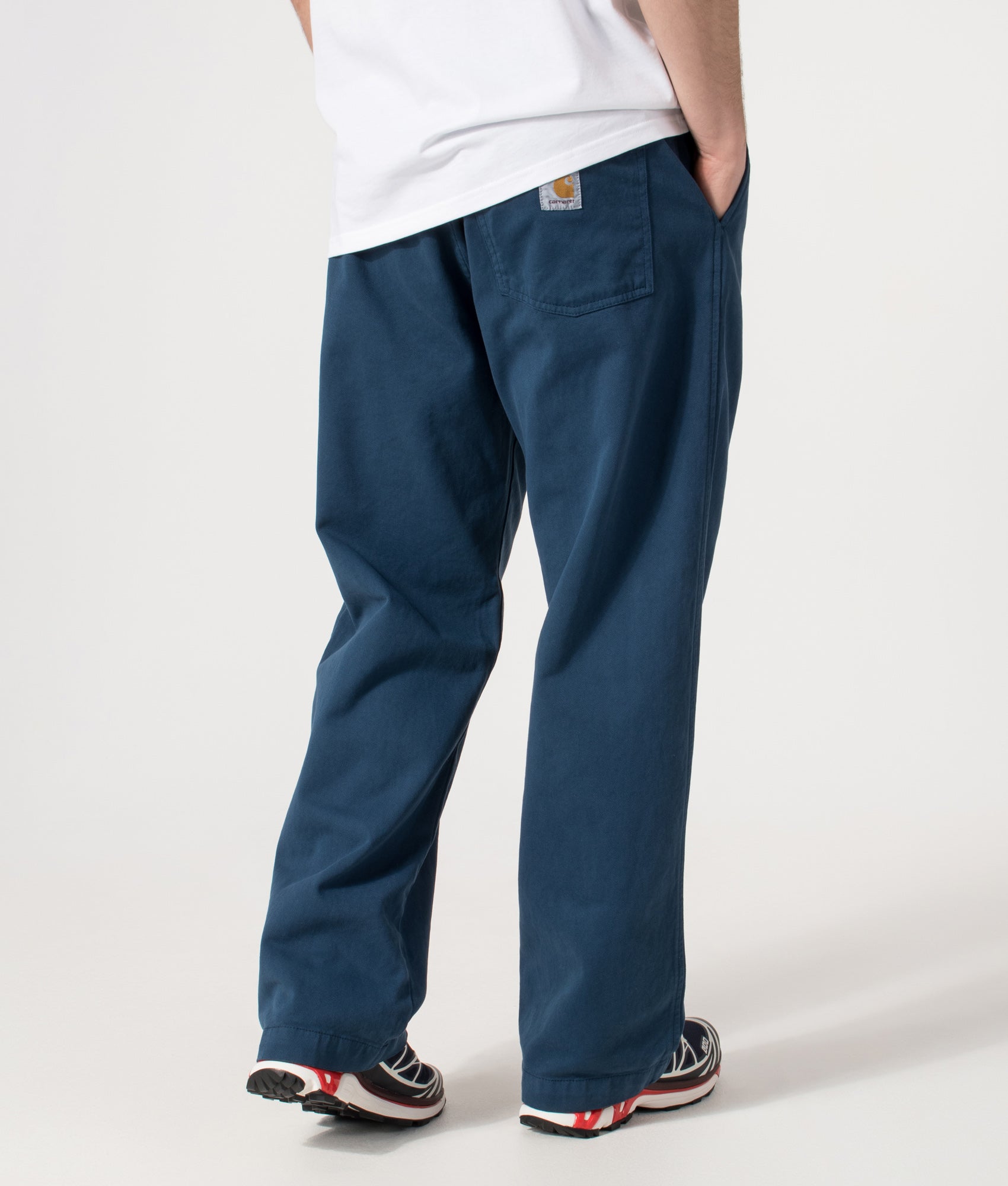 Carhartt WIP Relaxed Fit Floyde Pants  in Blue River at EQVVS Menswear. Angled model back shot.