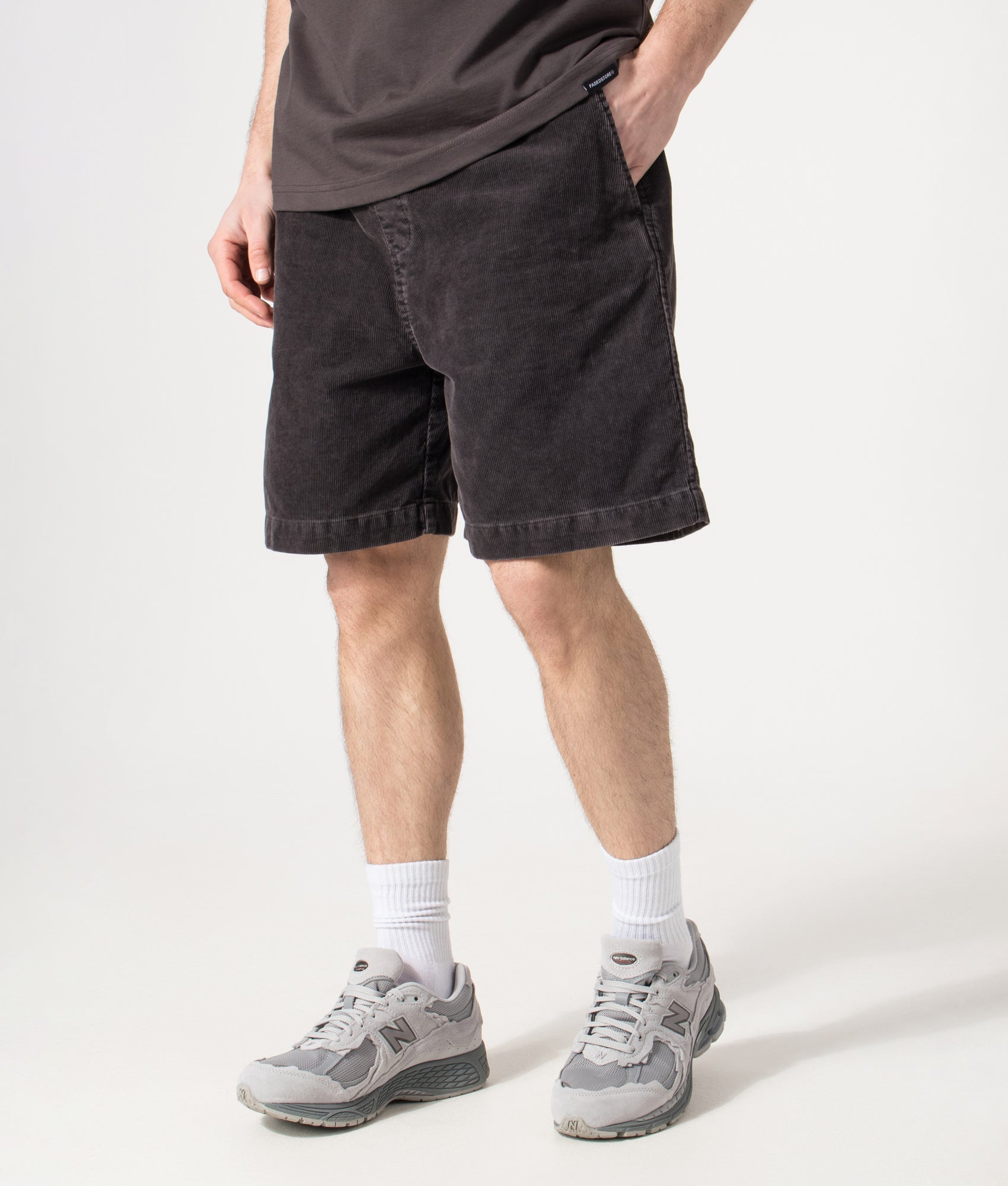 Carhartt WIP Relaxed Fit Reynold Shorts  in Shale at EQVVS Menswear. Model angled front shot.