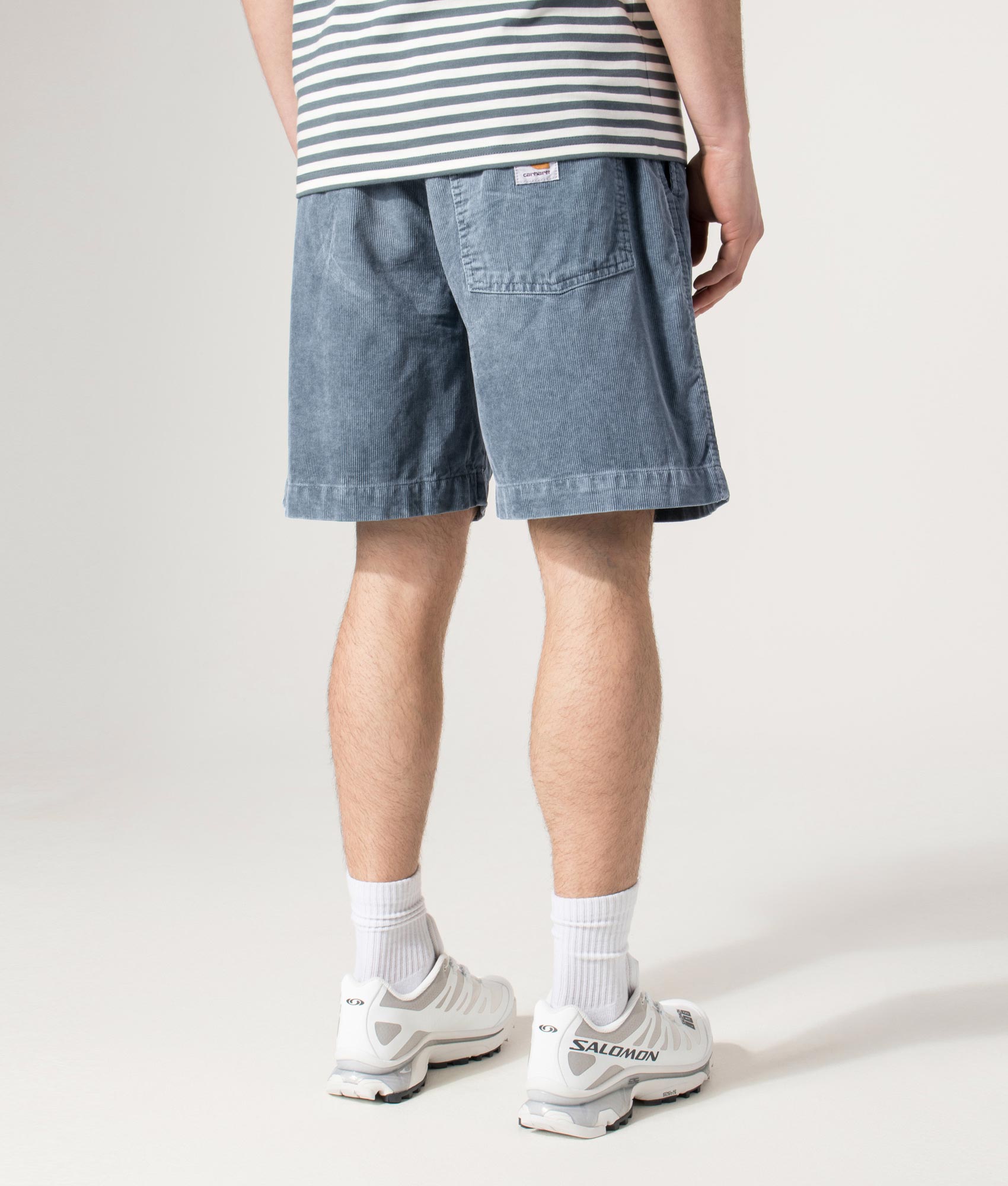 Carhartt WIP Relaxed Fit Reynold Shorts  in Cozy Blue at EQVVS Menswear.  Angled model back shot.