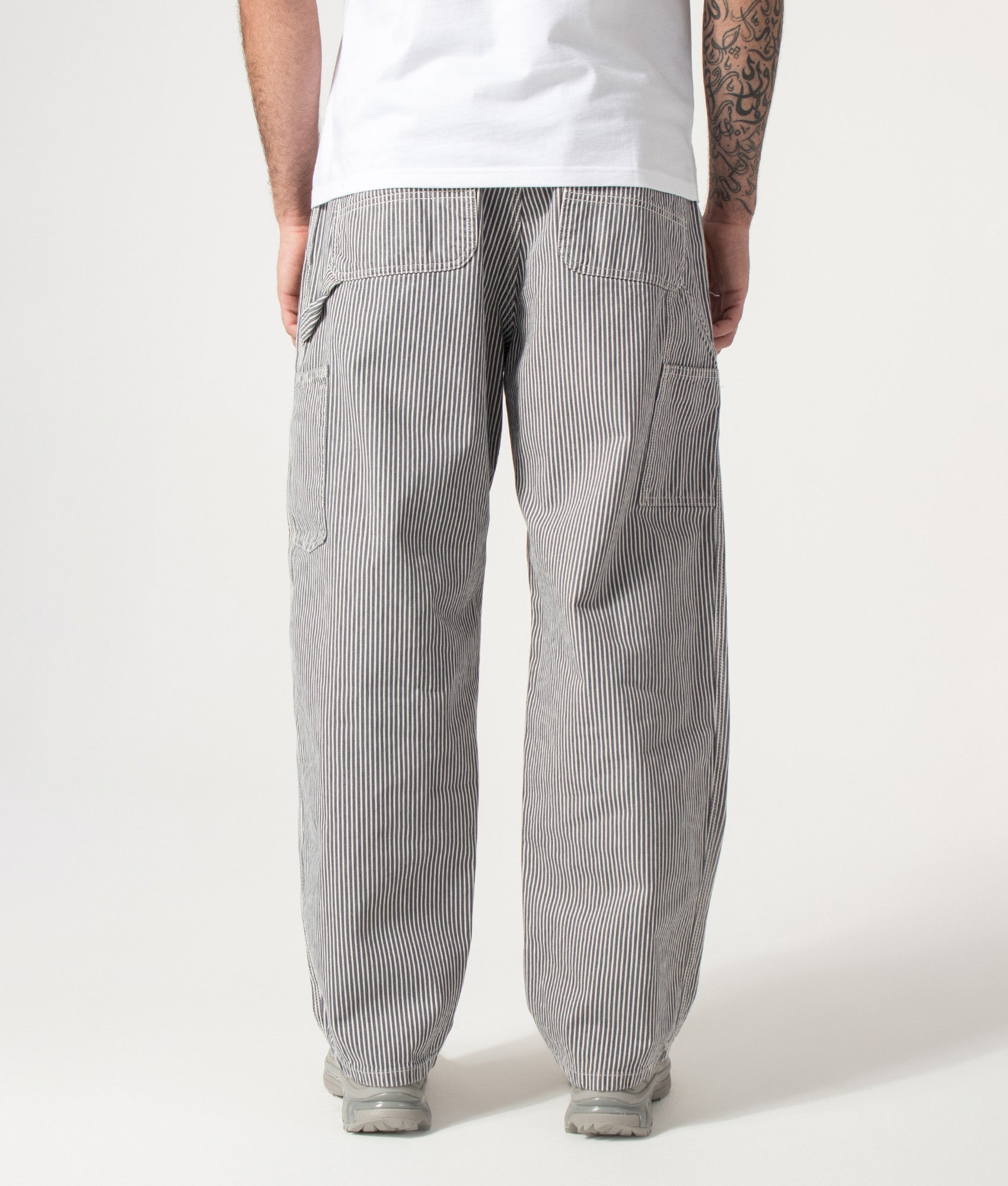 Carhartt WIP Relaxed Fit Mercer Single Knee Pants in Mercer Stripe, Graphite and Wax at EQVVS Menswear. Model back shot.