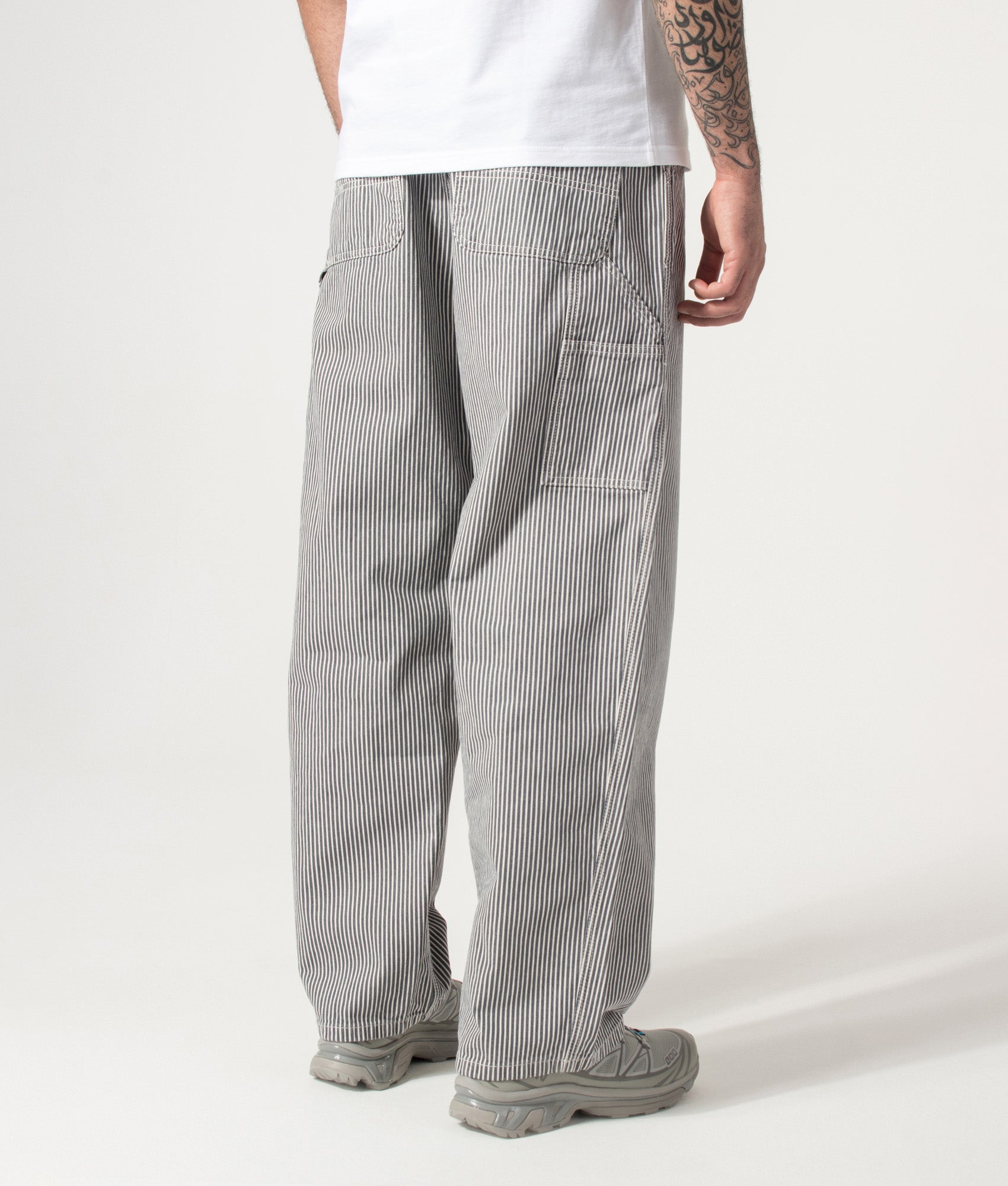Carhartt WIP Relaxed Fit Mercer Single Knee Pants in Mercer Stripe, Graphite and Wax at EQVVS Menswear. Angled back shot.
