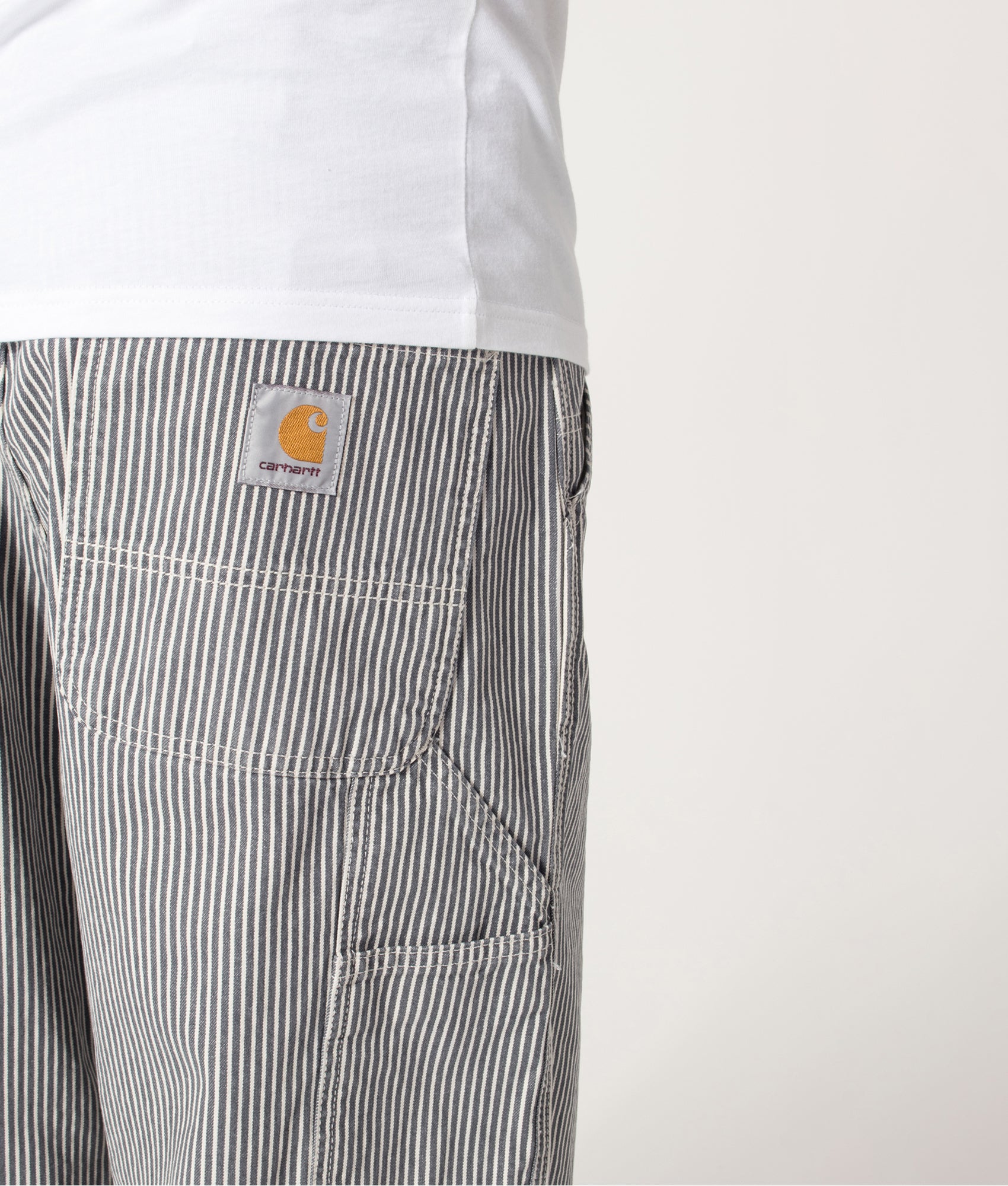Carhartt WIP Relaxed Fit Mercer Single Knee Pants in Mercer Stripe, Graphite and Wax at EQVVS Menswear. Back detail shot.