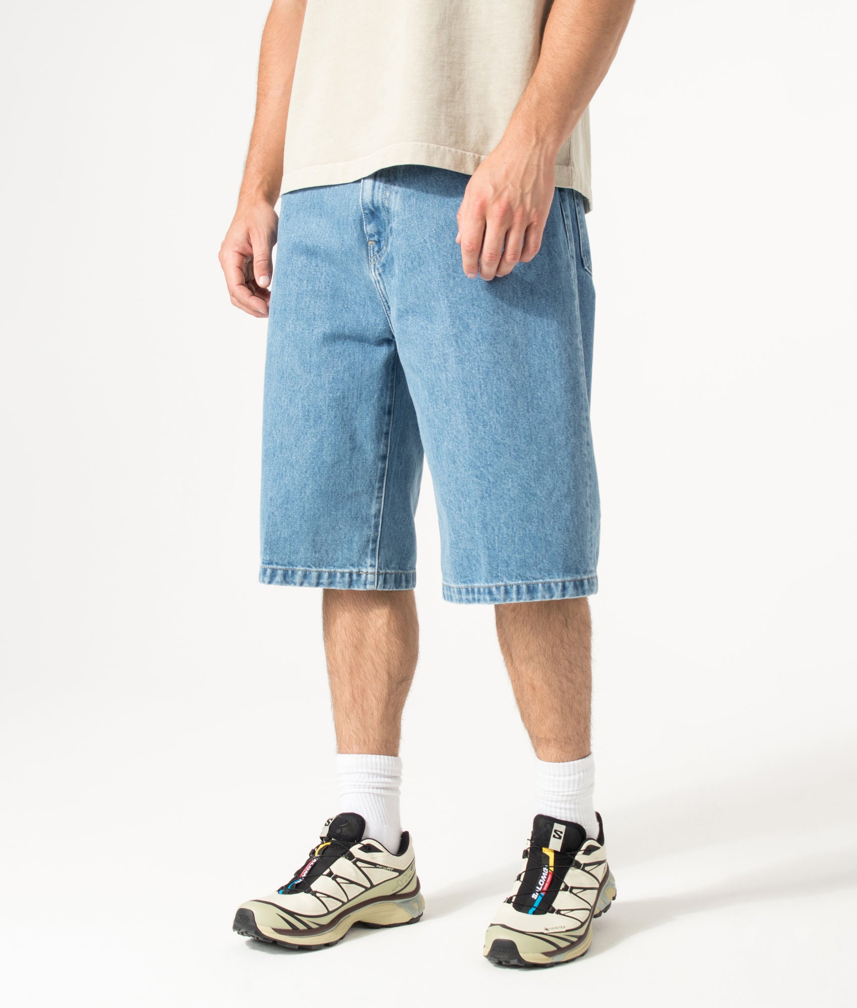 Carhartt WIP Loose Fit Langdon Denim Shorts in Blue at EQVVS Menswear. Angled model front shot.