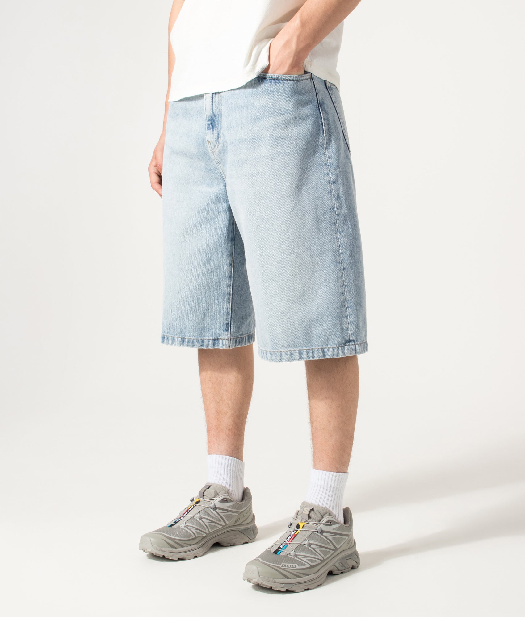 Carhartt WIP Loose Fit Langdon Denim Shorts in Heavy Worn Bleached Blue at EQVVS Menswear. Angled model front shot.