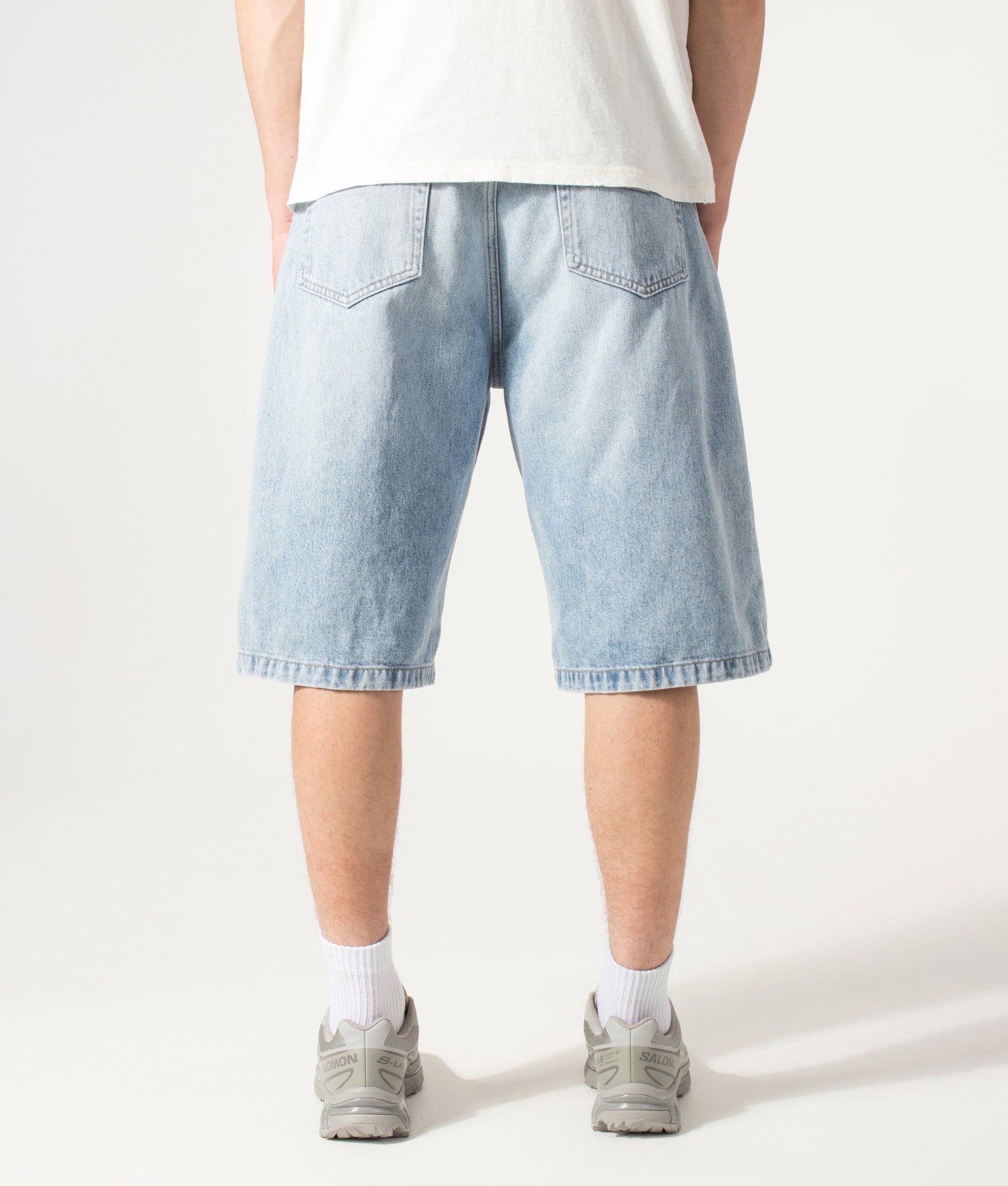 Carhartt WIP Loose Fit Langdon Denim Shorts in Heavy Worn Bleached Blue at EQVVS Menswear. Model back shot.