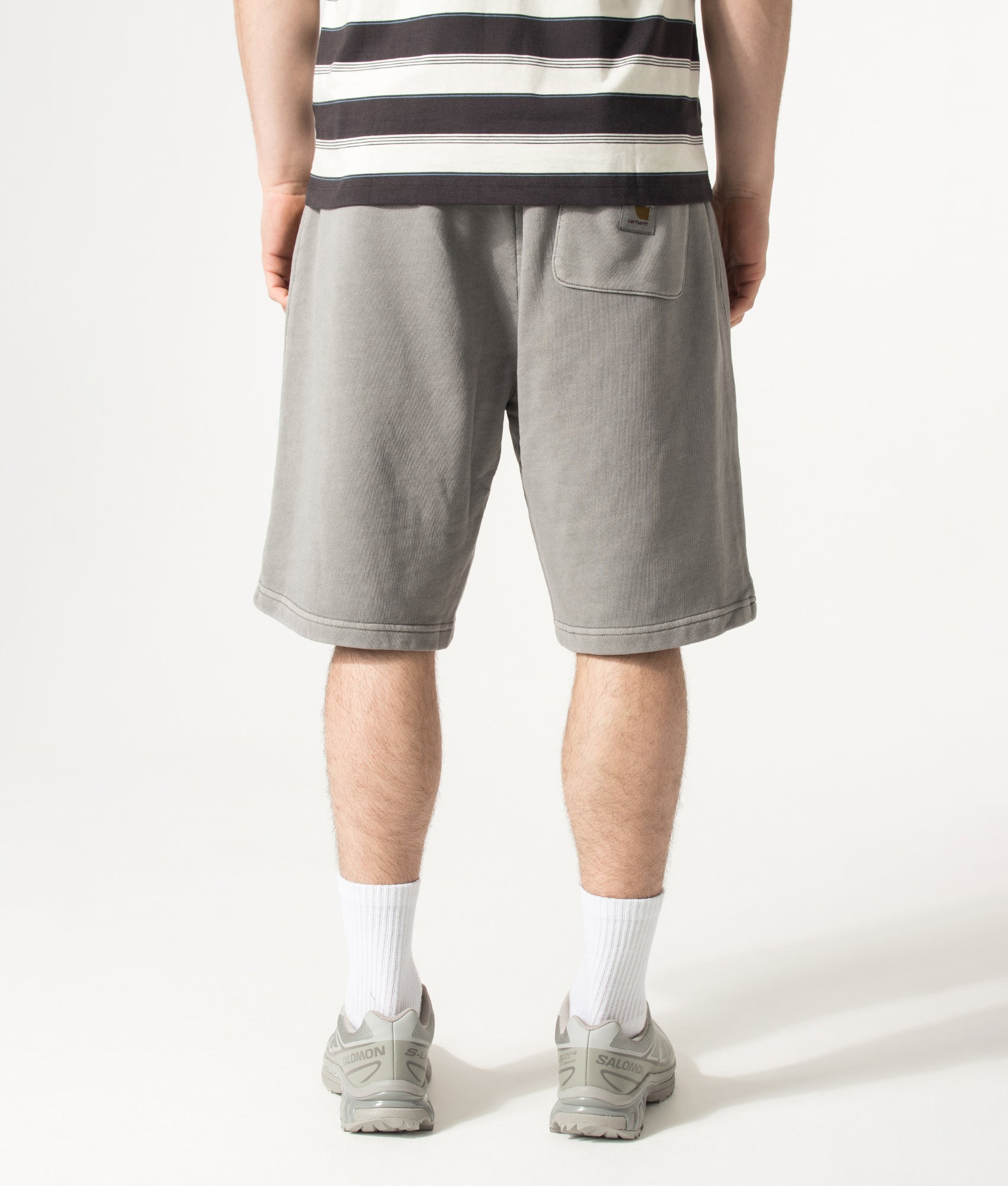 Carhartt WIP Balloon Fit Nelson Sweat Shorts in Yosemite at EQVVS Menswear. Model back shot.