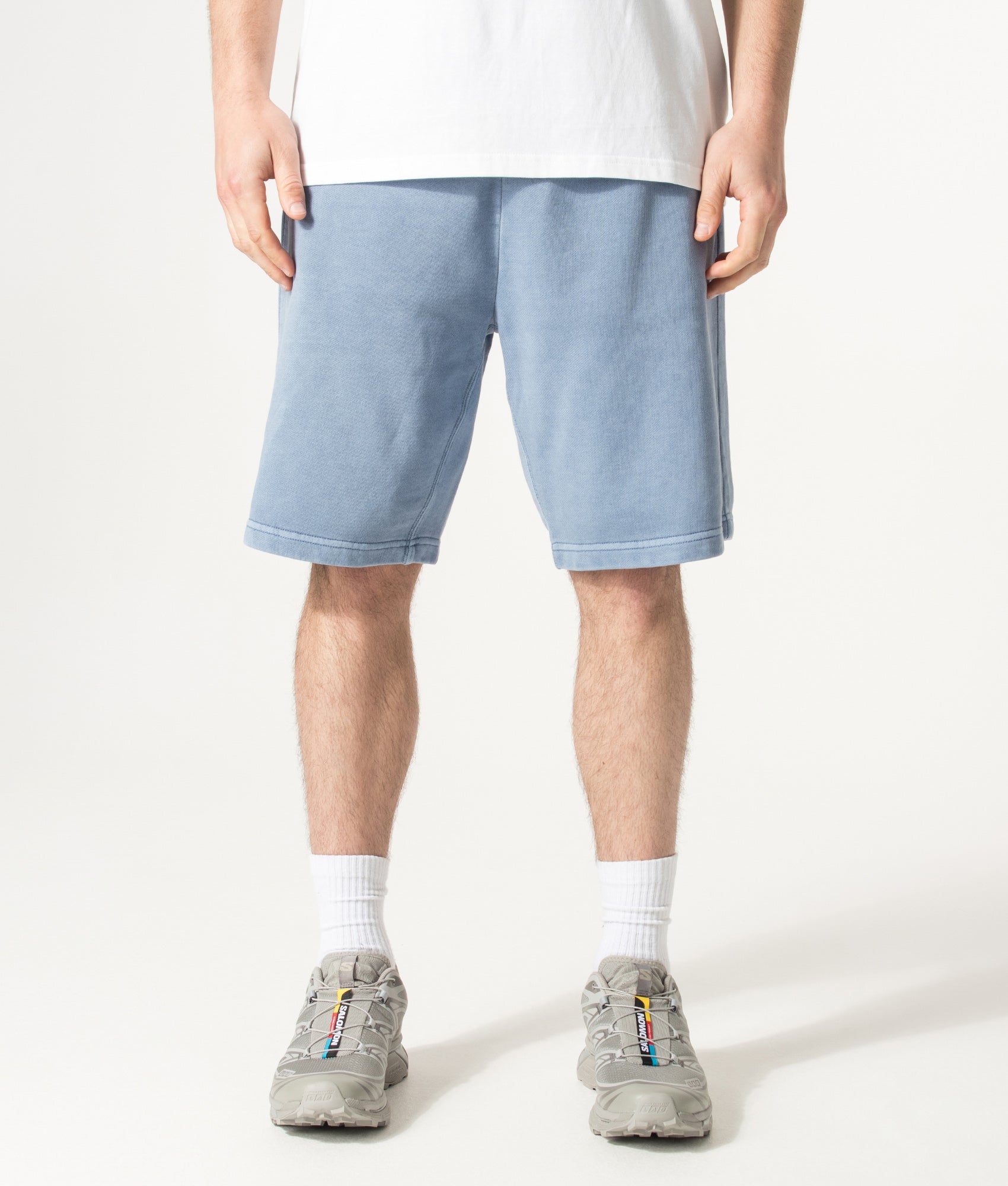 Carhartt WIP Balloon Fit Nelson Sweat Shorts in Gentle Blue at EQVVS Menswear. Model front shot.