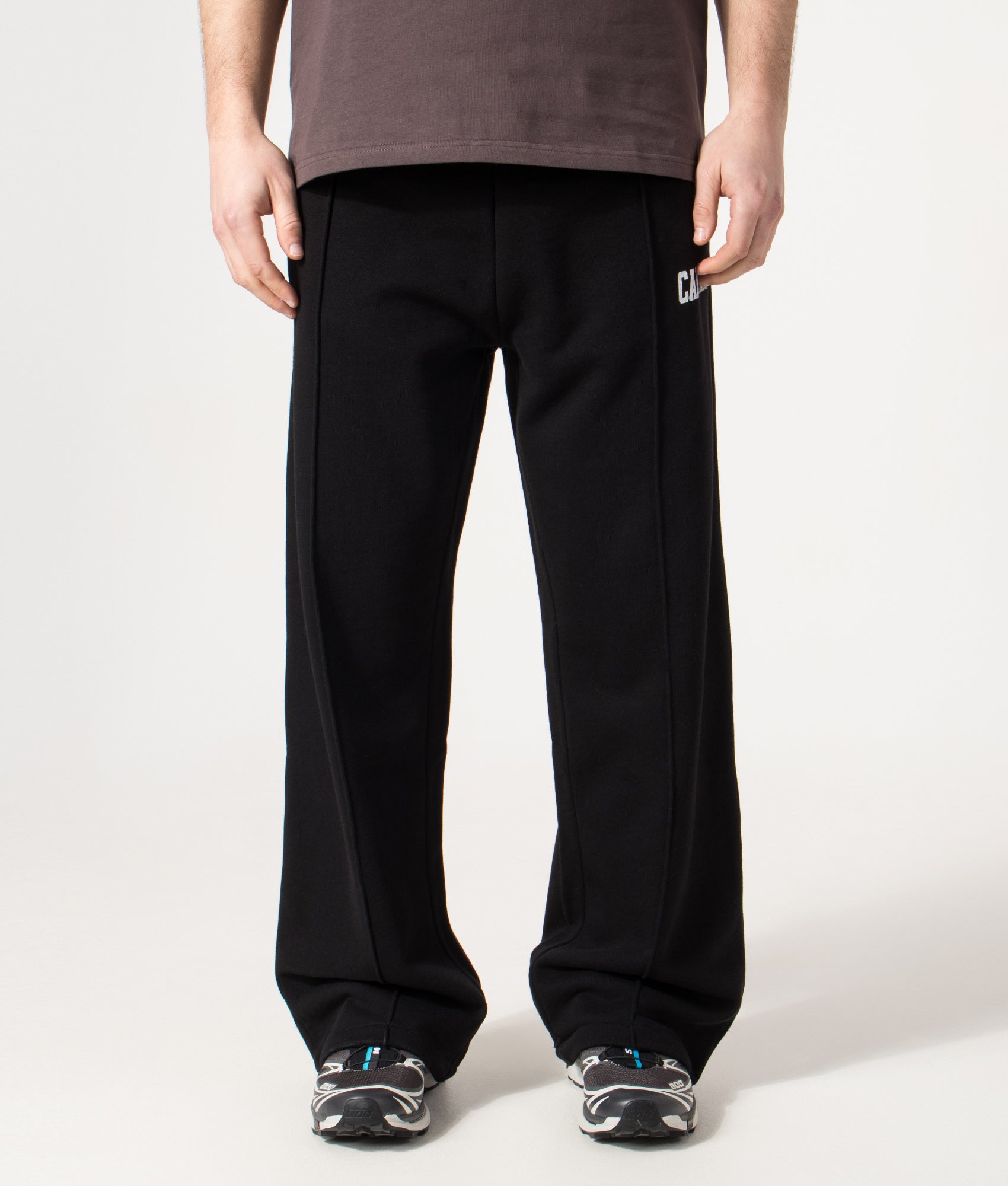 Carhartt WIP Relaxed Fit Pond Corps Sweatpants in Black at EQVVS Menswear. Model front shot.