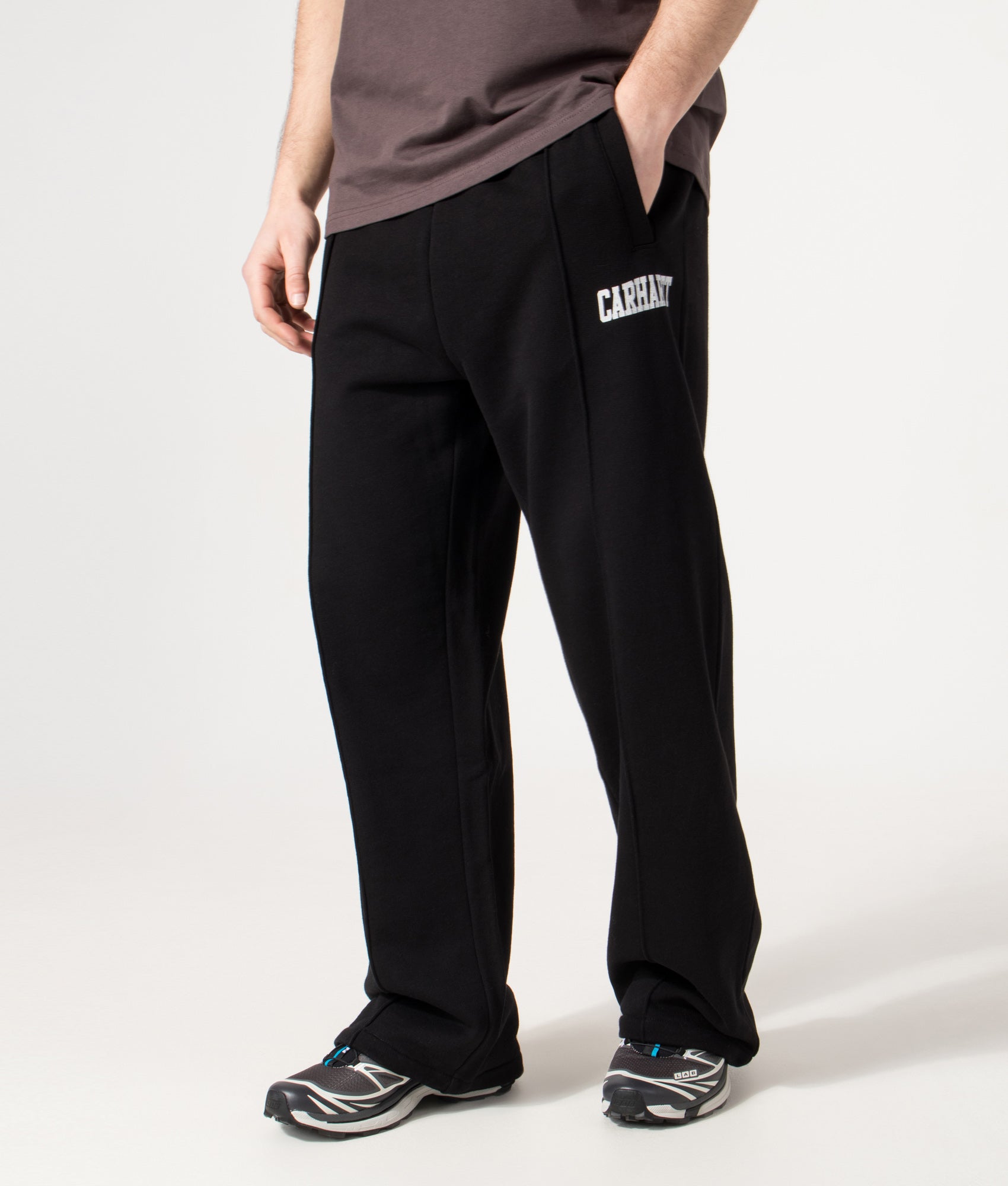 Carhartt WIP Relaxed Fit Pond Corps Sweatpants in Black at EQVVS Menswear. Angled model front shot.