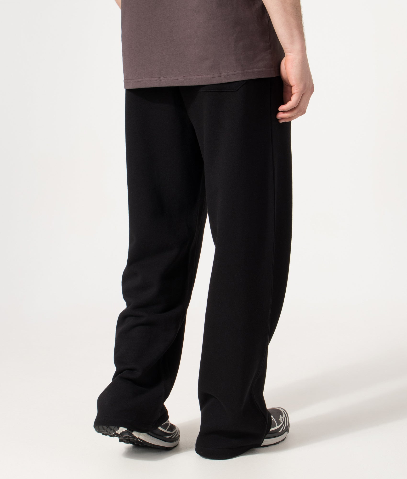 Carhartt WIP Relaxed Fit Pond Corps Sweatpants in Black at EQVVS Menswear. Model back shot.