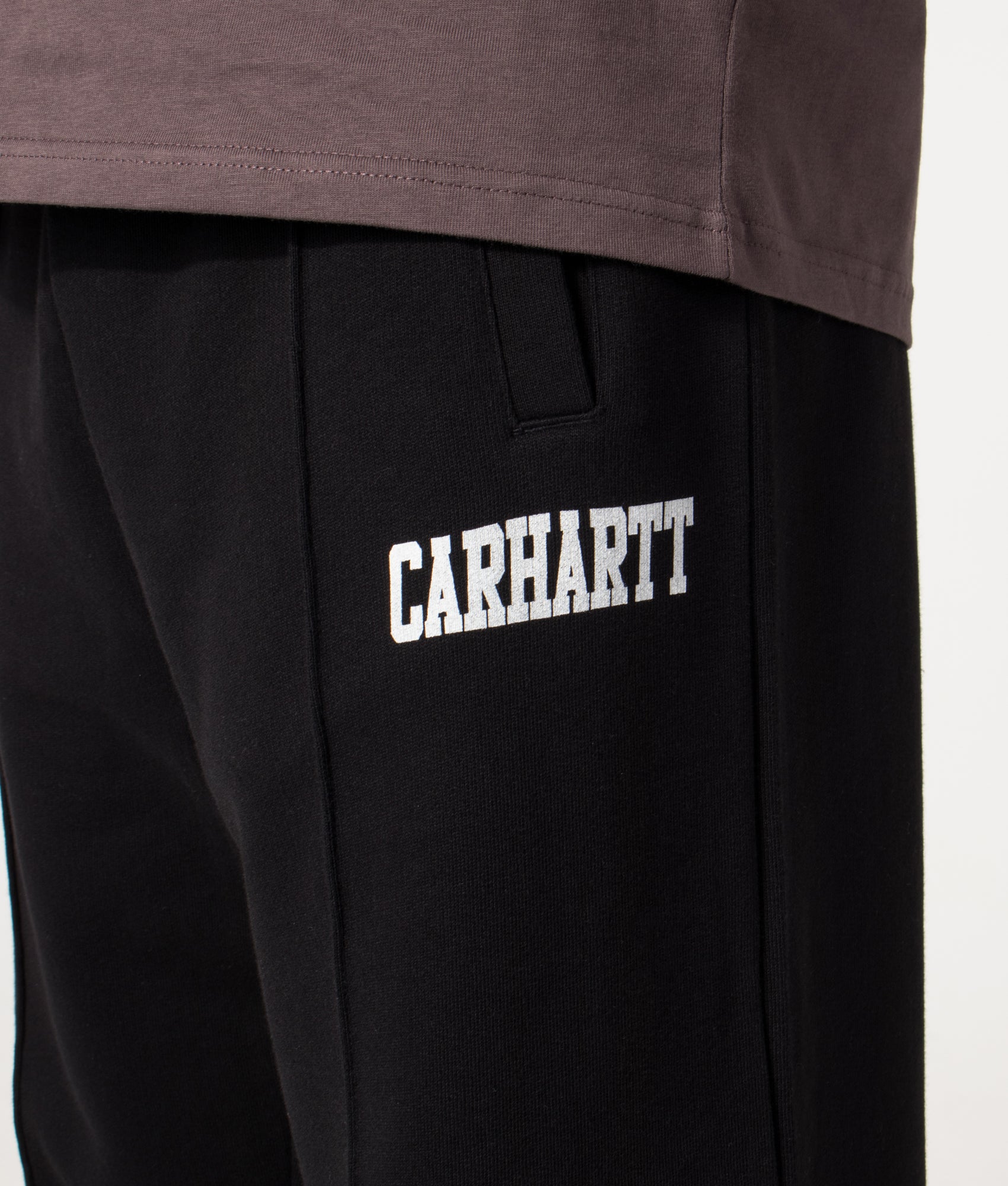 Carhartt WIP Relaxed Fit Pond Corps Sweatpants in Black at EQVVS Menswear. Detail shot.