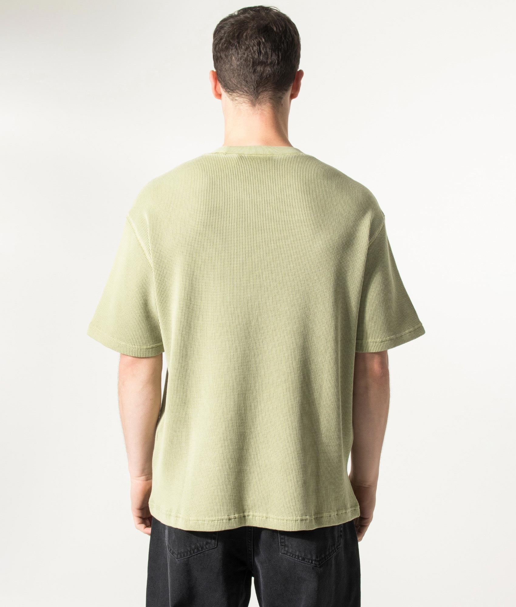 Carhartt WIP Relaxed Fit Nelson Waffle T-Shirt in Gentle Green at EQVVS Menswear. Model back shot.