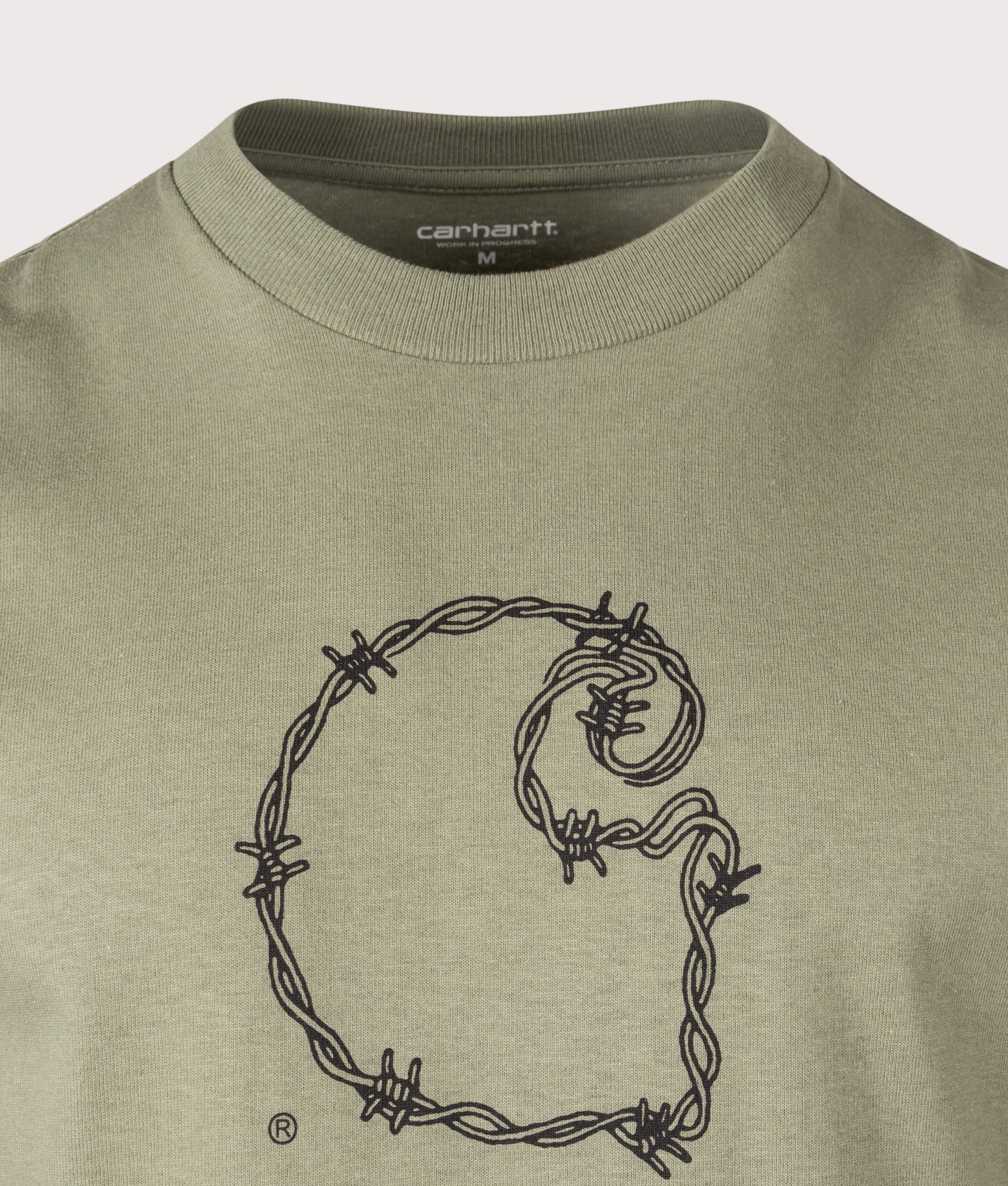 Carhartt WIP Relaxed Fit Barbwire C T-Shirt in Dollar Green at EQVVS Menswear. Detail shot.
