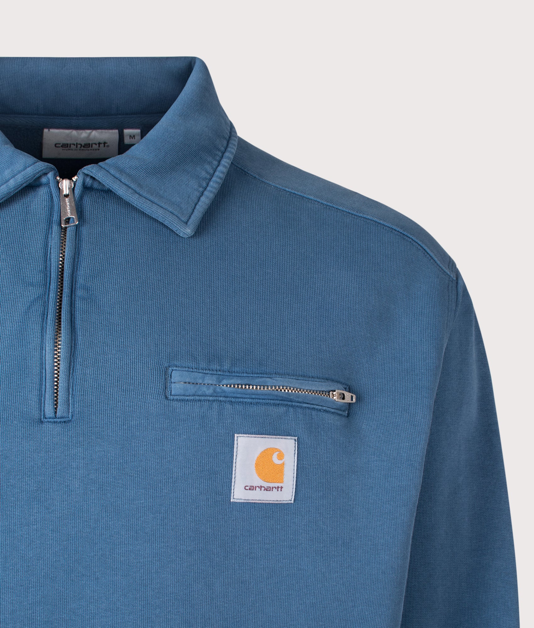 Carhartt WIP Oversized Half Zip Detroit Sweatshirt in Blue River at EQVVS Menswear. Detail shot.