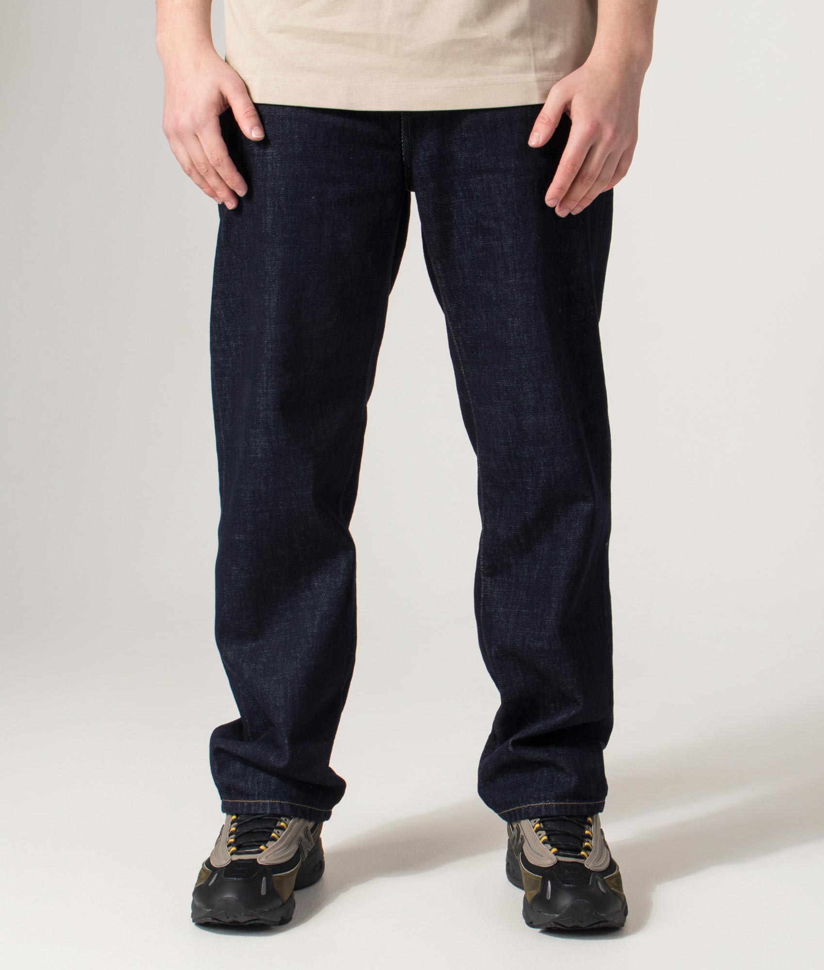 Carhartt WIP Regular Fit Tapered Aaron Pants in Blue at EQVVS Menswear. Front shot.