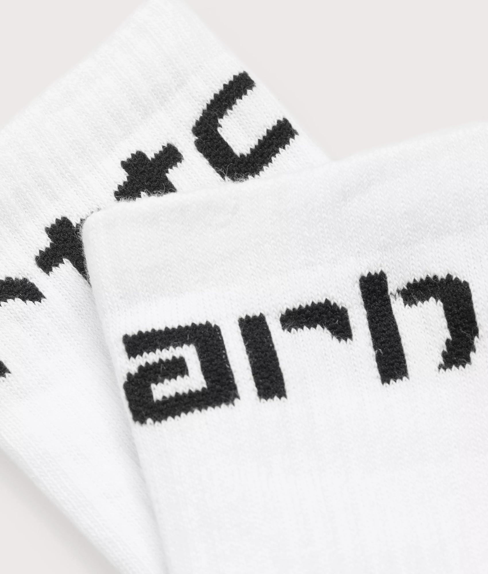 Carhartt WIP Carhartt Socks in White and Black at EQVVS Menswear. Detail shot.