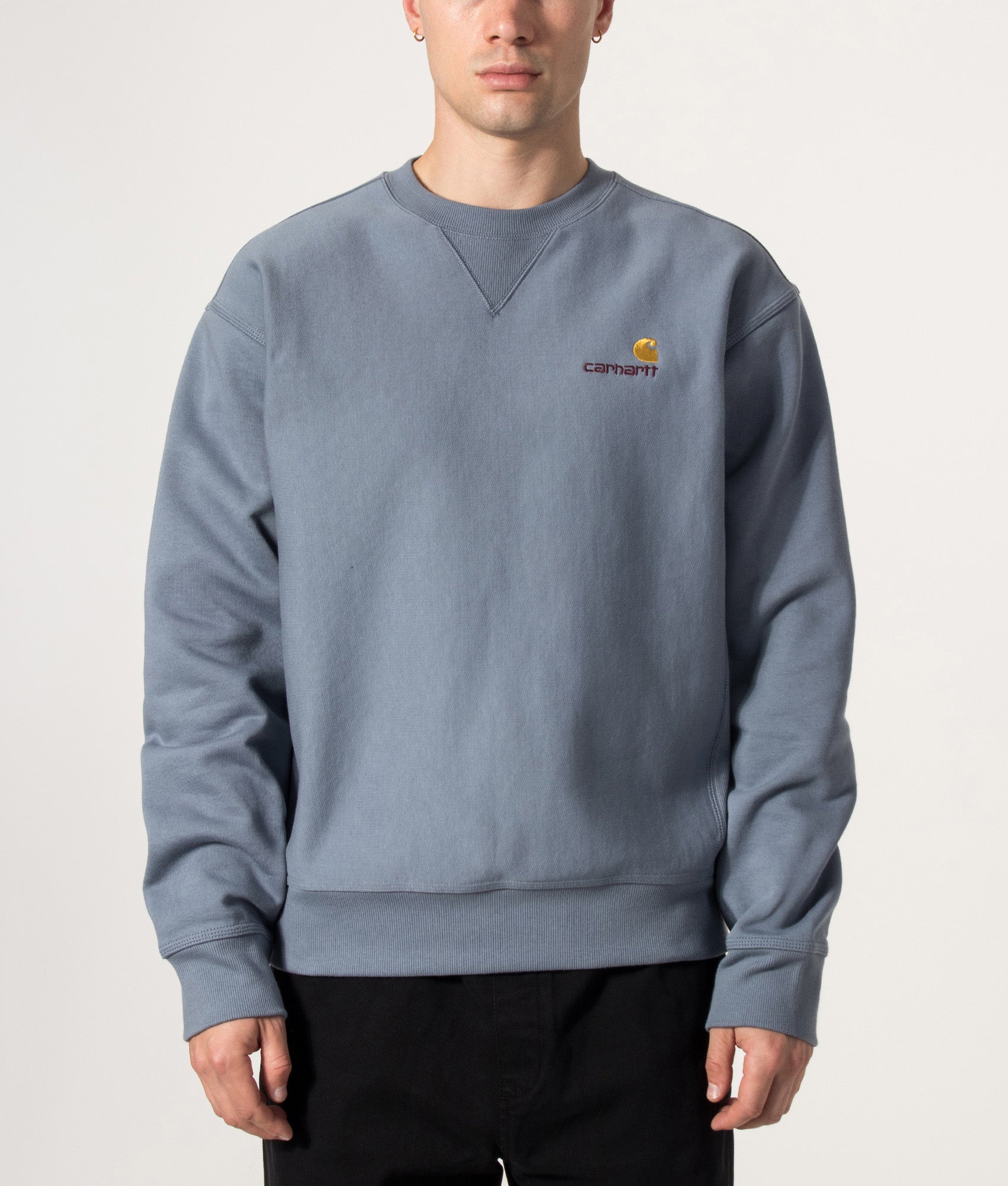 Carhartt WIP Loose Fit American Script Sweatshirt in Shady Blue at EQVVS Menswear. Model front shot.