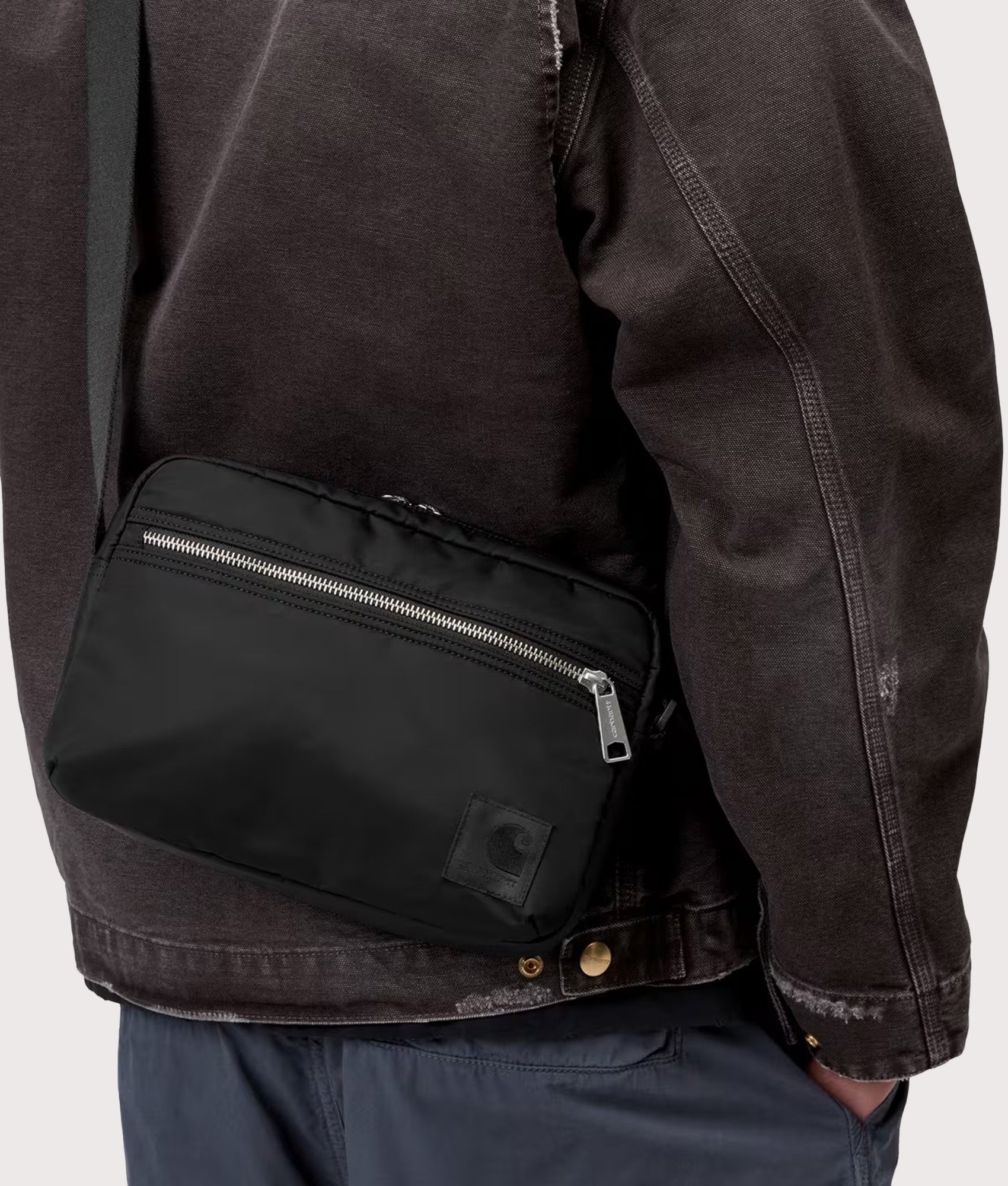 Carhartt WIP Otis Shoulder Bag in  Black at EQVVS Menswear. Model shot.