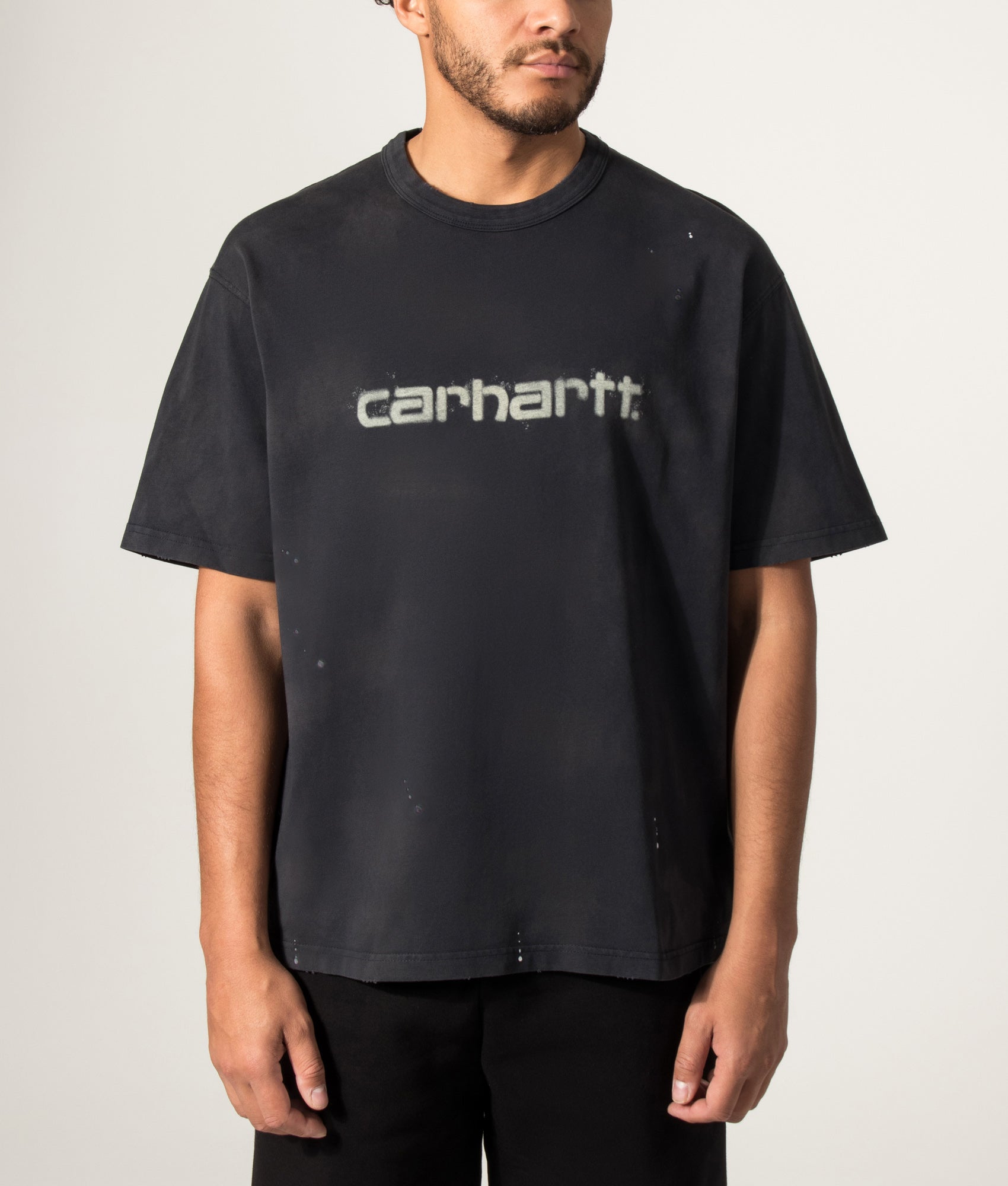 Carhartt WIP Oversized Fit Painter T-Shirt in Black at EQVVS Menswear. Model front shot.
