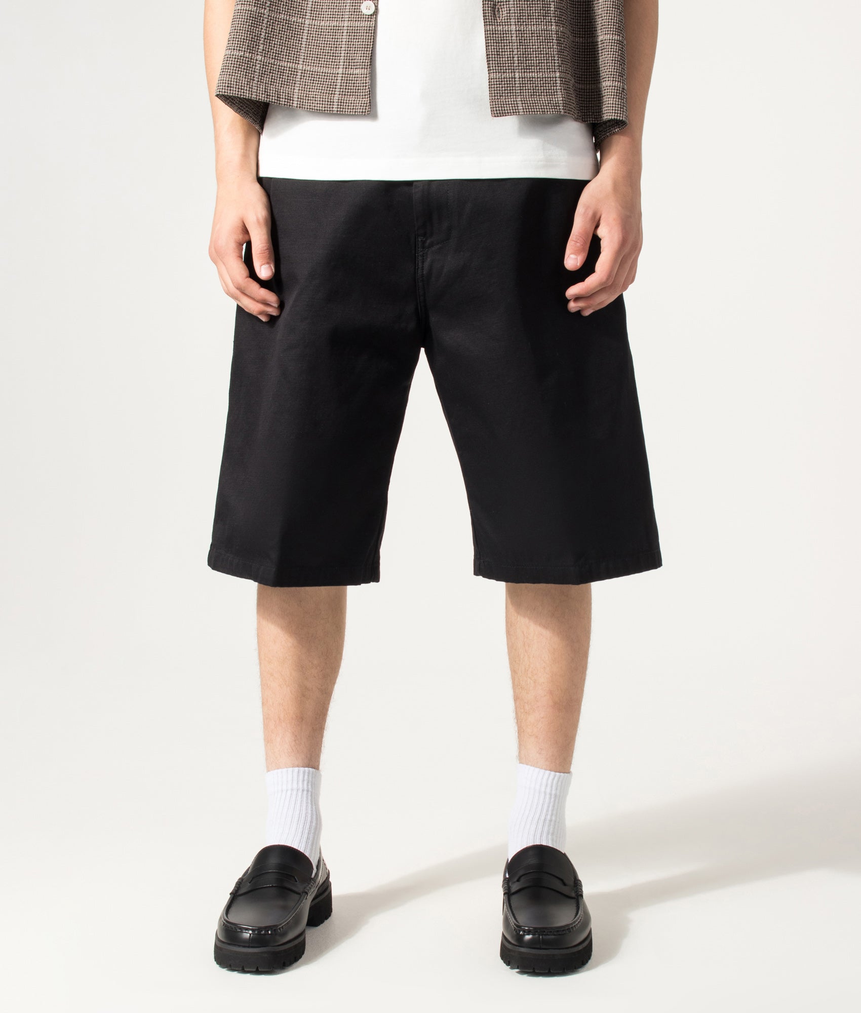 Carhartt WIP Loose Fit Brader Shorts in Black at EQVVS Menswear. Model front shot.
