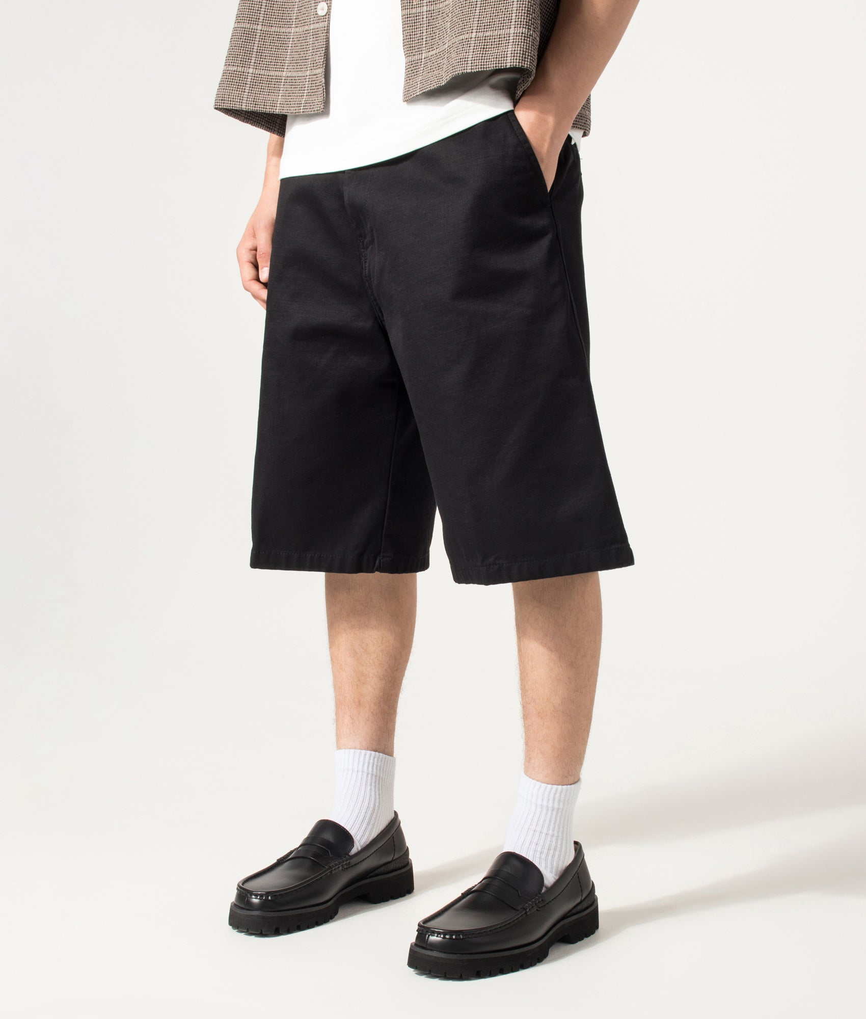 Carhartt WIP Loose Fit Brader Shorts in Black at EQVVS Menswear. Angled front shot.