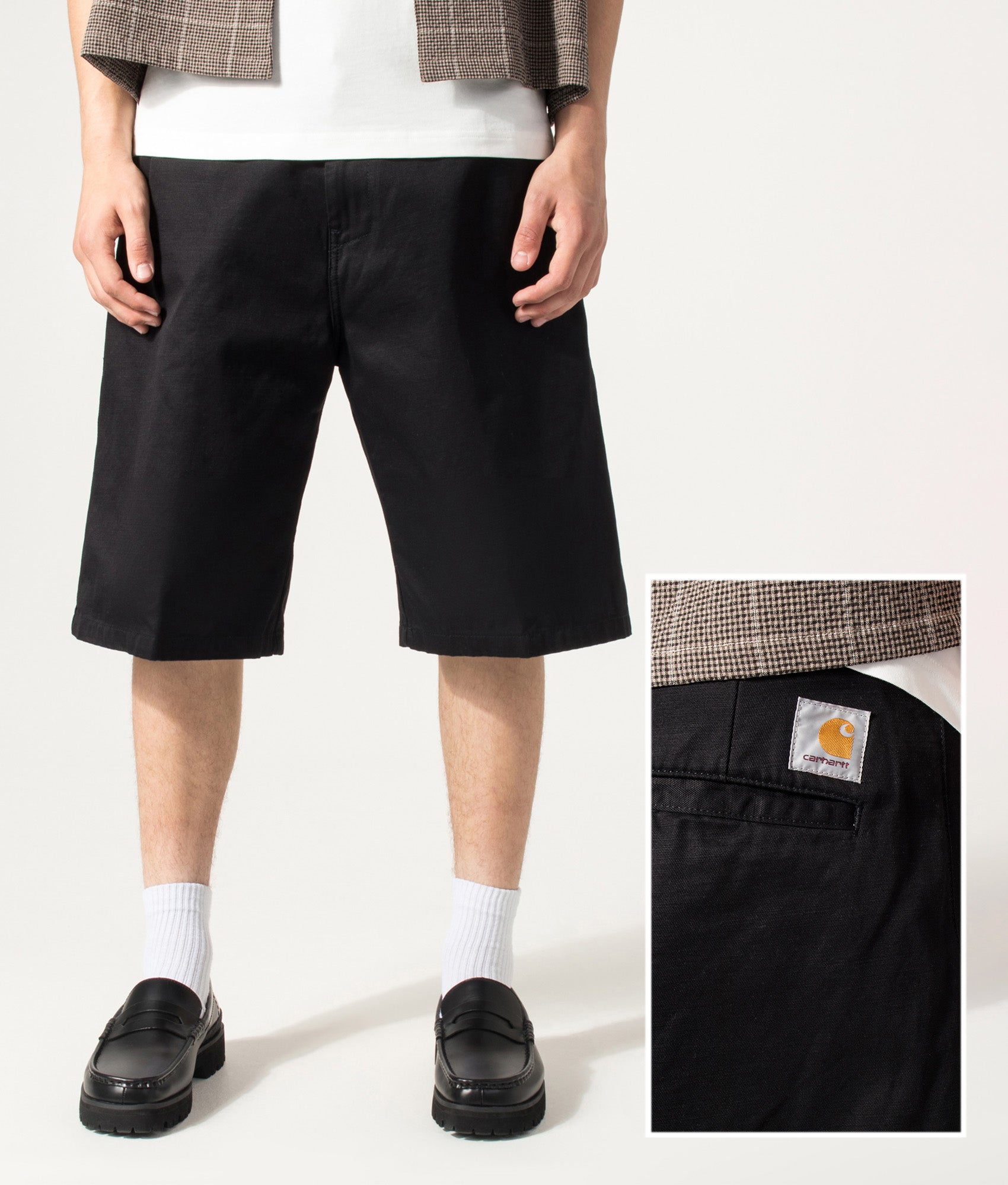 Carhartt WIP Loose Fit Brader Shorts in Black at EQVVS Menswear. Model front and back shot.