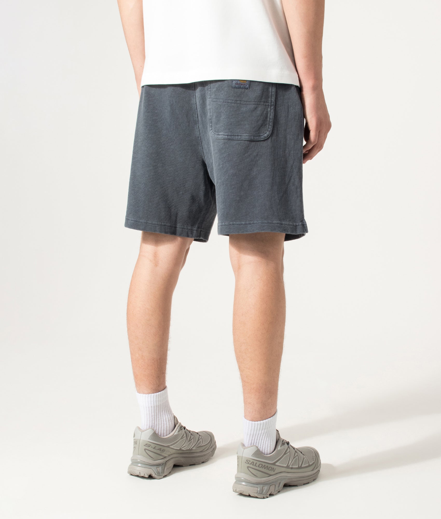 Carhartt WIP Balloon Fit Harper Sweat Shorts in Carbon at EQVVS Menswear. Model back shot.
