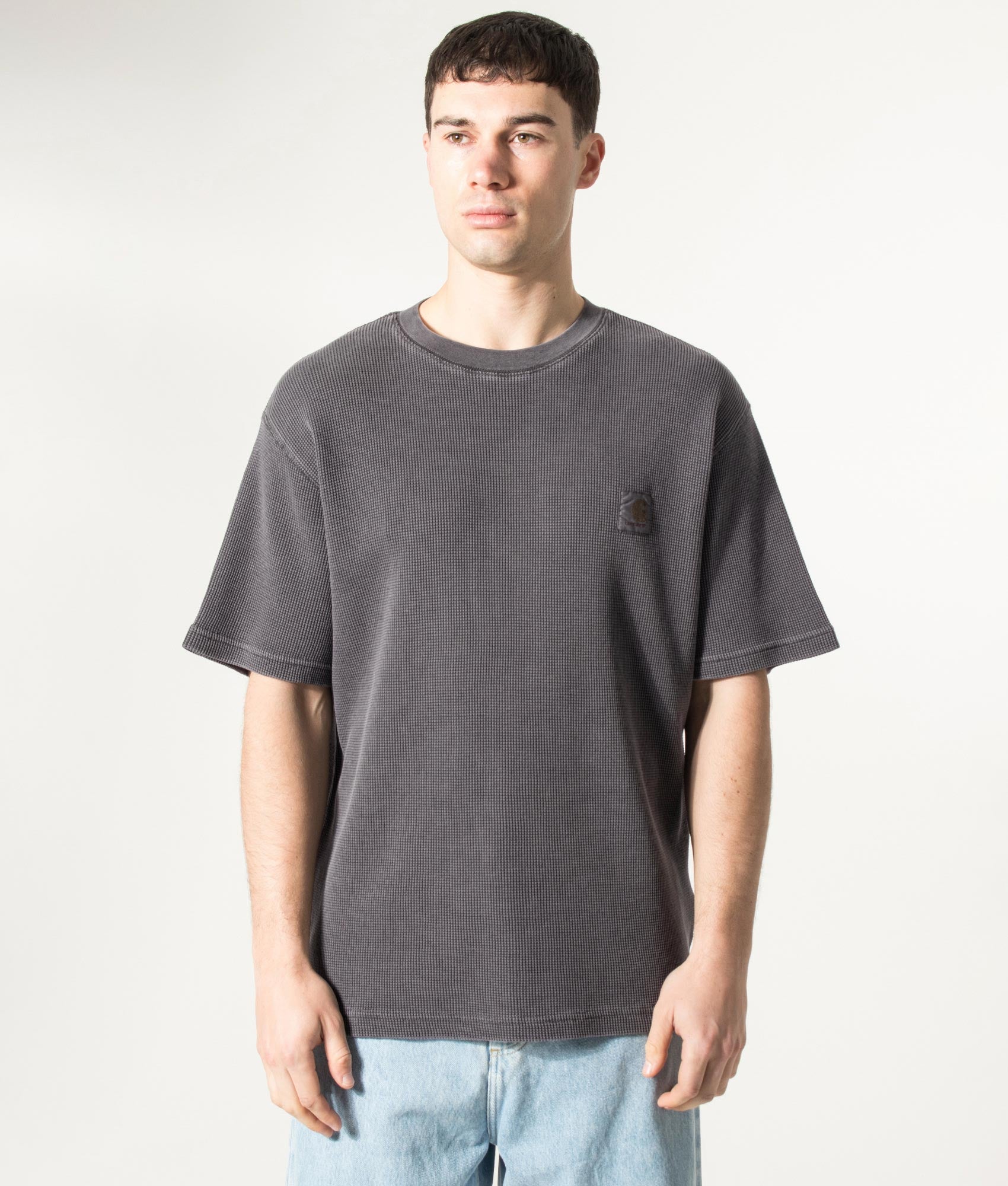 Carhartt WIP Relaxed Fit Nelson Waffle T-Shirt in Black at EQVVS Menswear. Model front shot.